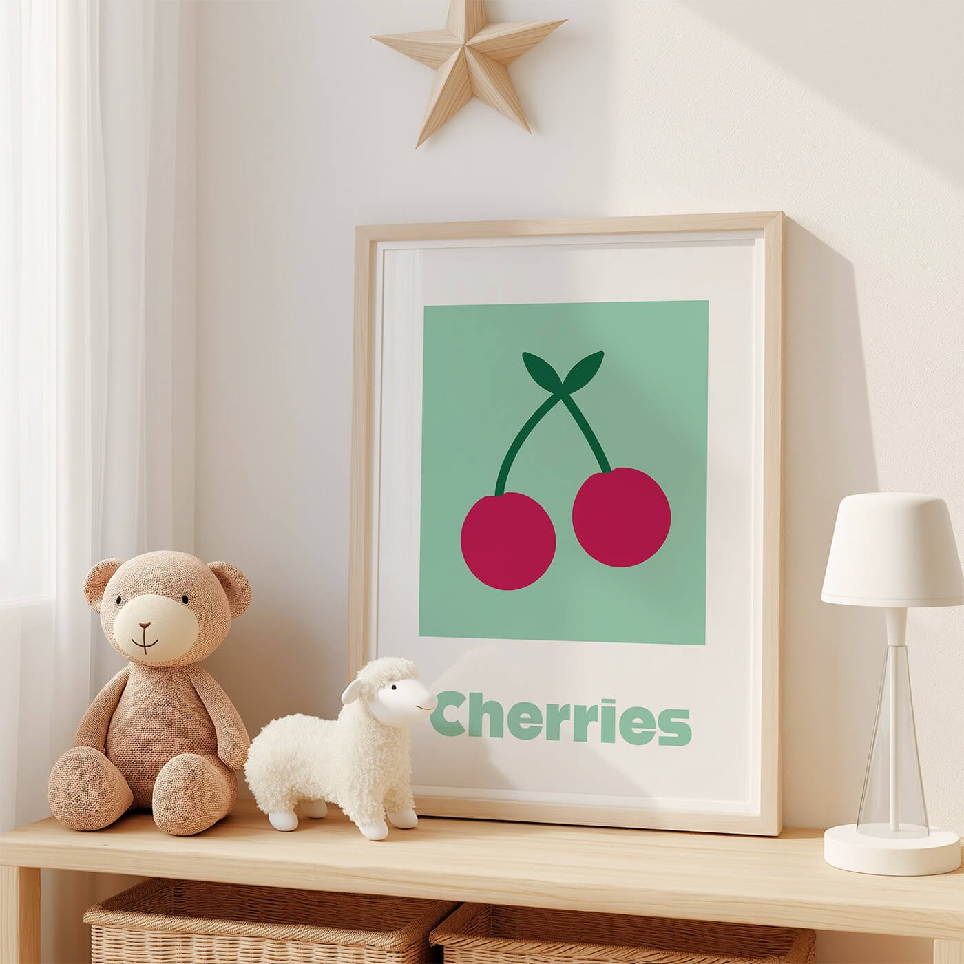 Cherries learning print displayed in frame on wooden shelf in kids room next to two stuffed animals