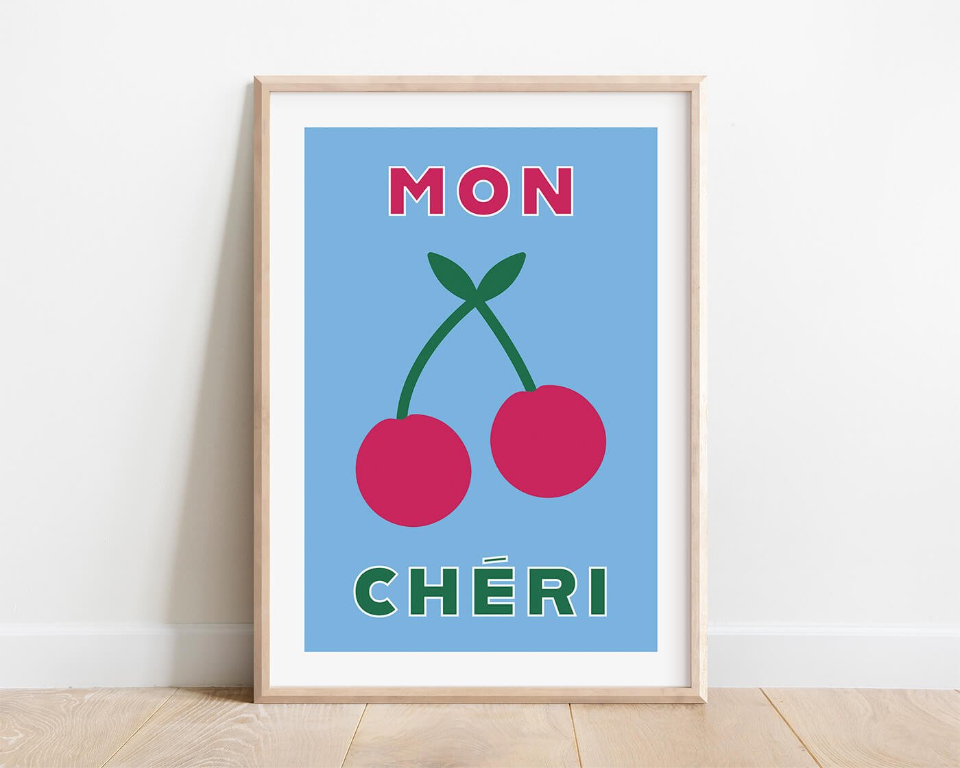 Blue Mon Cheri chic typography poster in a natural wood frame styled against a white background by Amatus