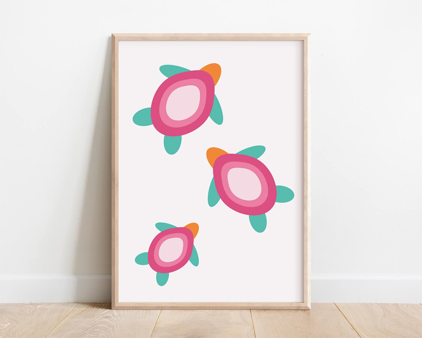 Three abstract pink turtle illustrations in soft blush and warm pink hues displayed in a natural wooden frame, creating modern coastal wall art