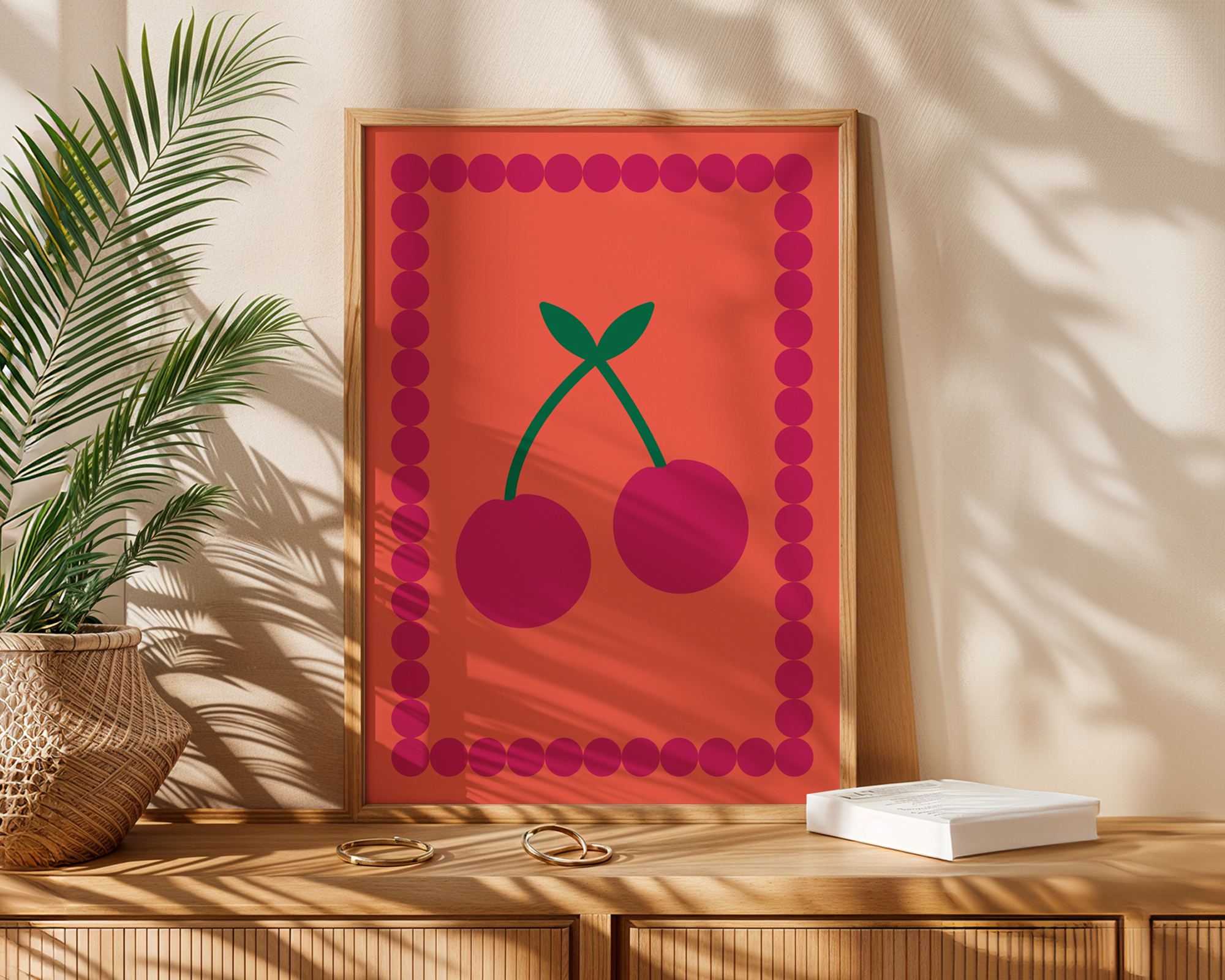decorative cherry print in frame on wooden desk with sunlight cast over