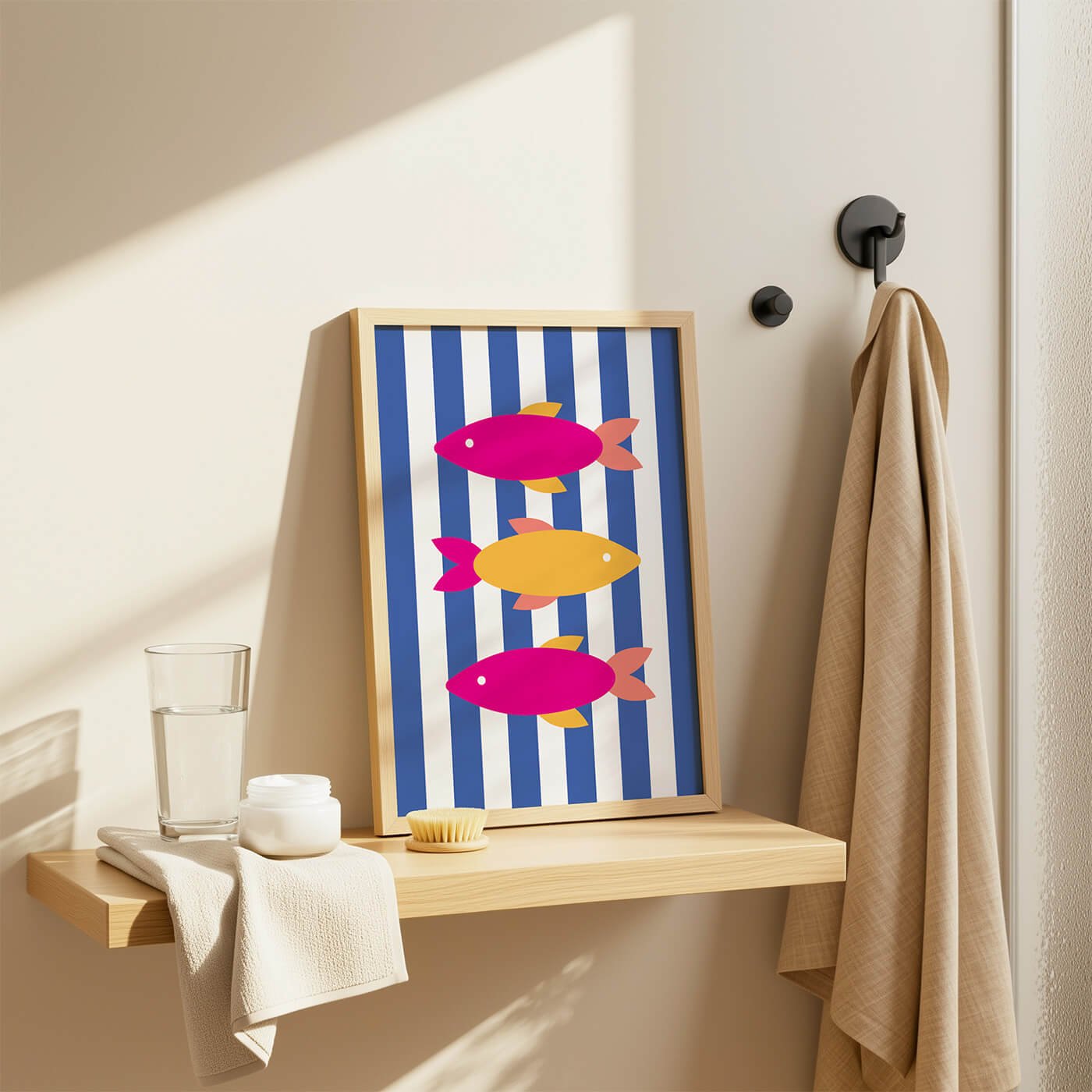 Retro fish wall art featuring pink and yellow fish on a blue striped background styled in a modern bathroom