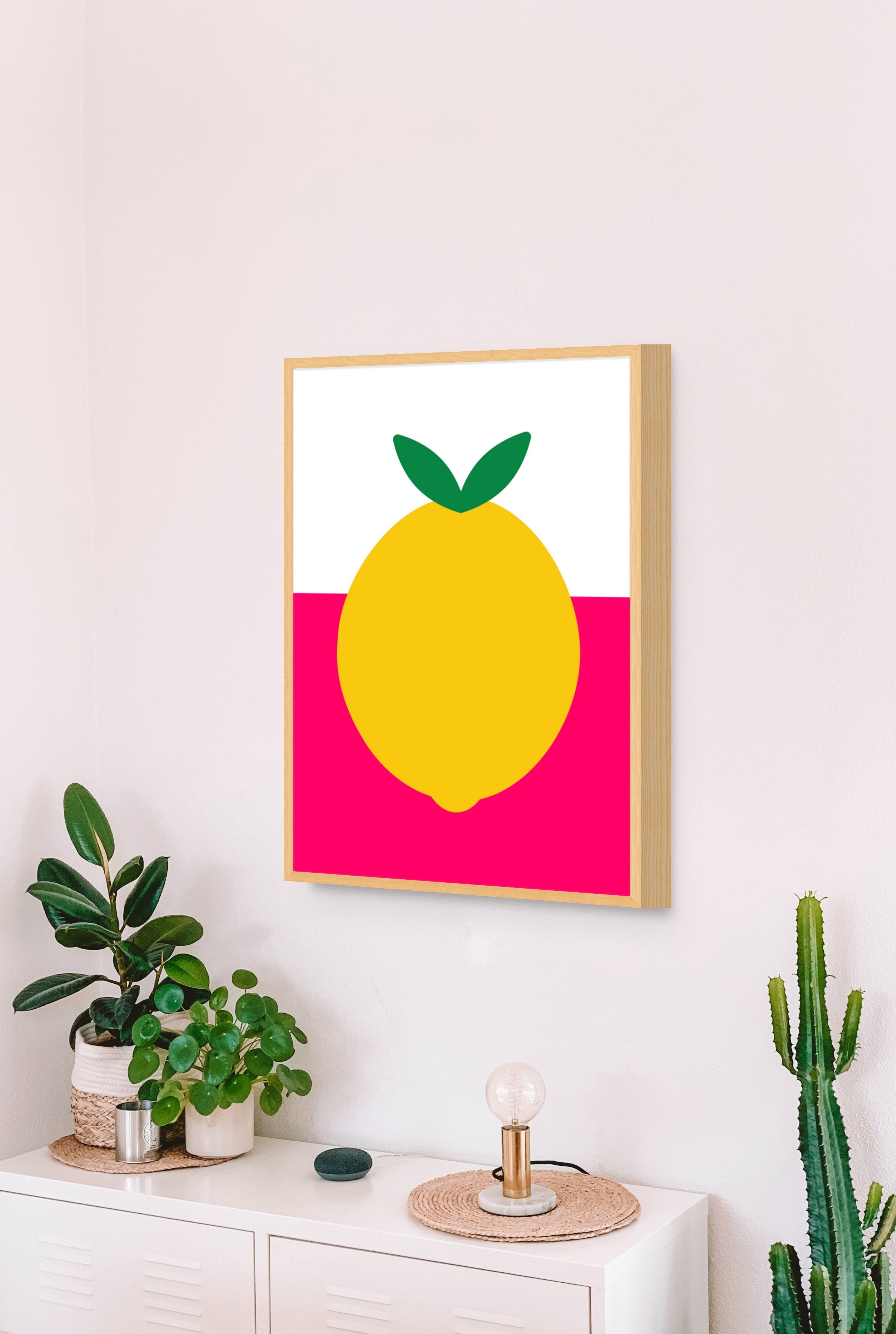 bright pink print of lemon in frame on kitchen wall