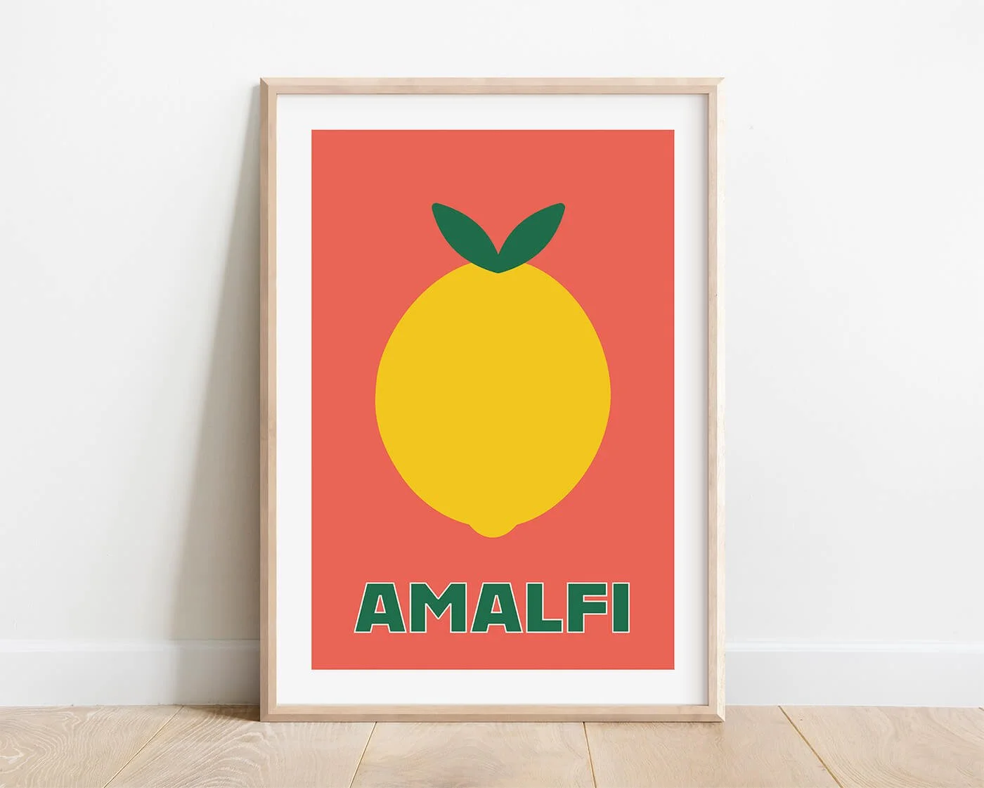 A minimalist yellow Amalfi lemon art print with a warm terracotta orange background, enclosed in a natural wood frame against a minimalist white living room wall.