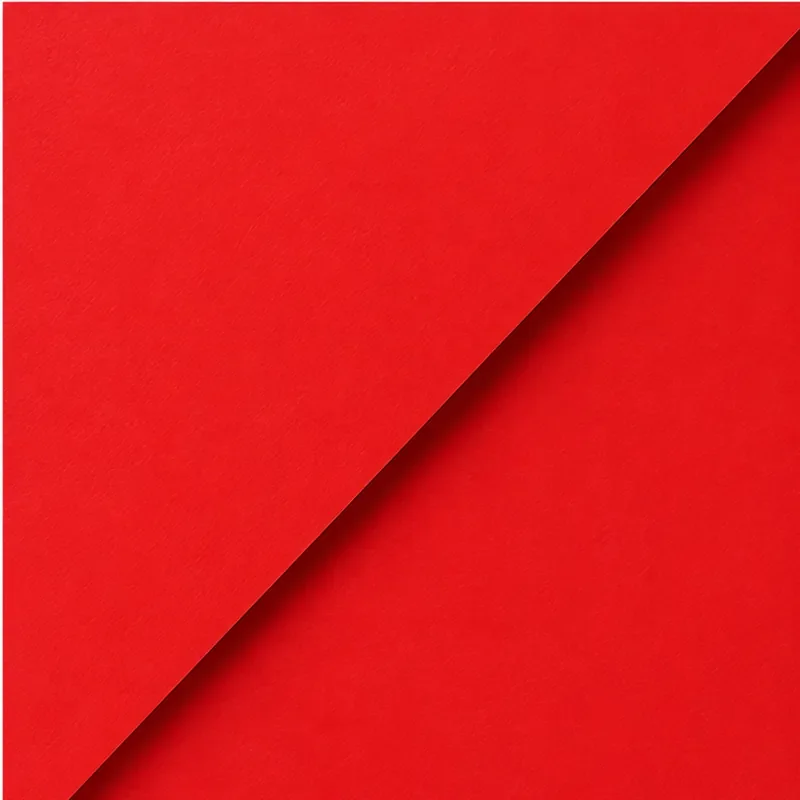 A red sheet of paper with a corner lifted, revealing a shadow underneath.