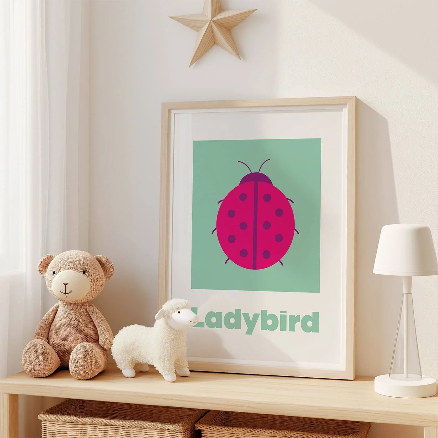 Ladybird Learning Print displayed in a modern oak frame on a shelf in a contemporary children's bedroom with two soft toys. Colourful ladybird wall art on a green background
