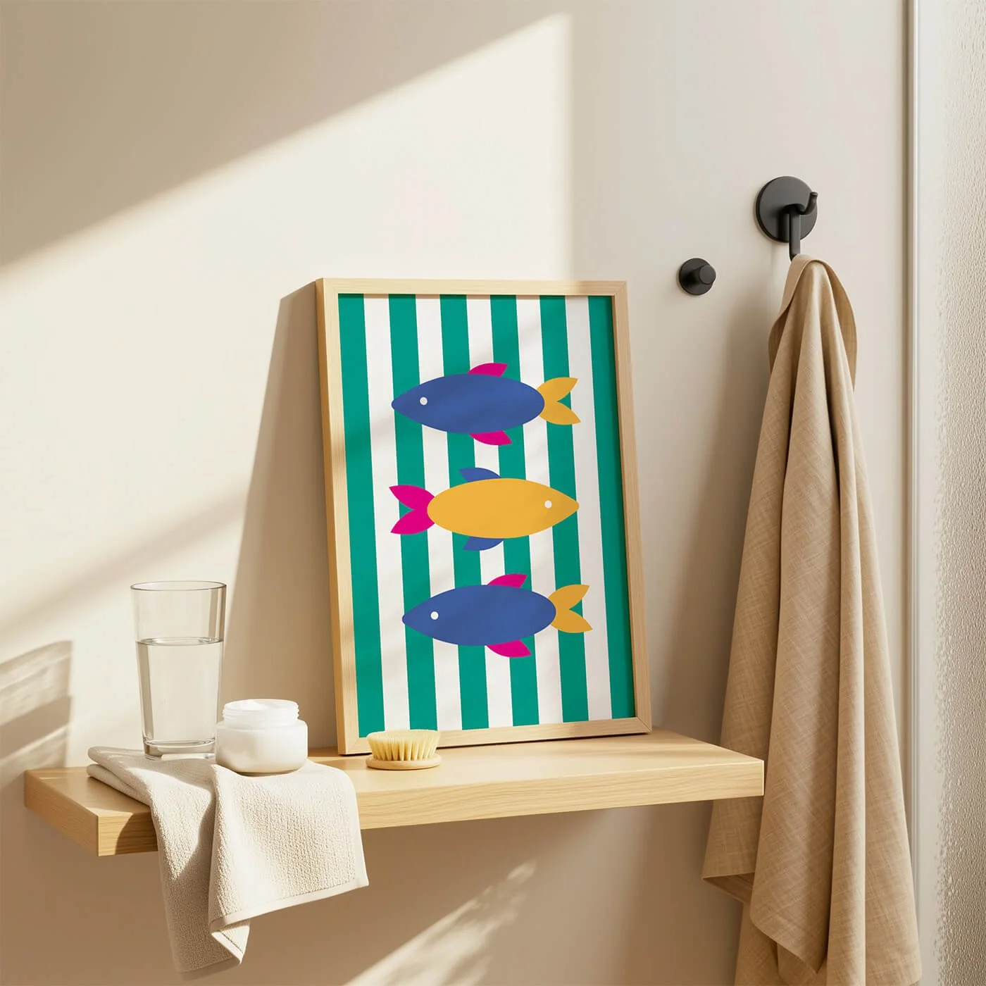 Colourful fish art print with blue and yellow fish on a green striped background displayed on a bathroom shelf