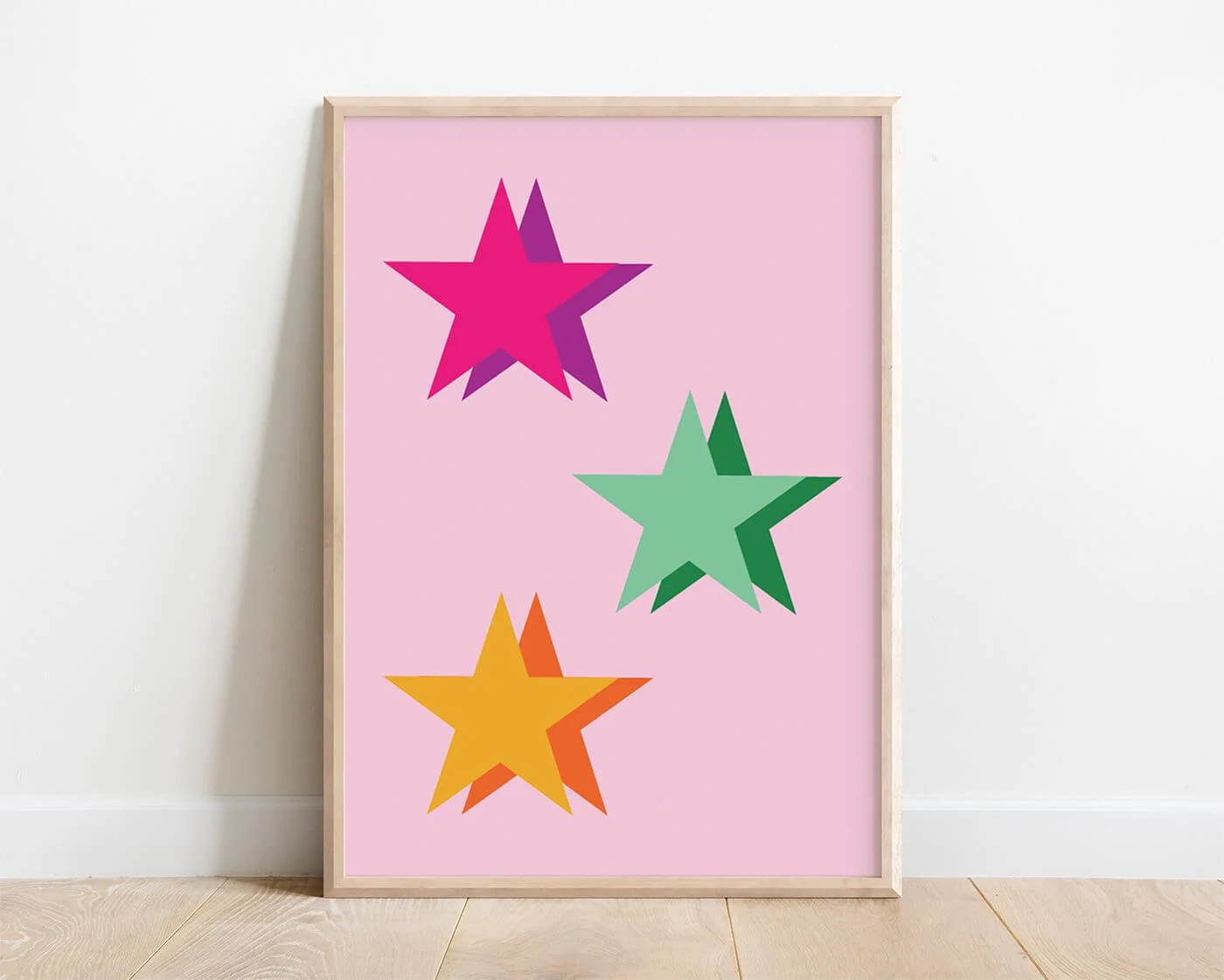 Colourful kids wall art with a large green star and smaller pink and yellow stars on a pink background, perfect for girls' room decor