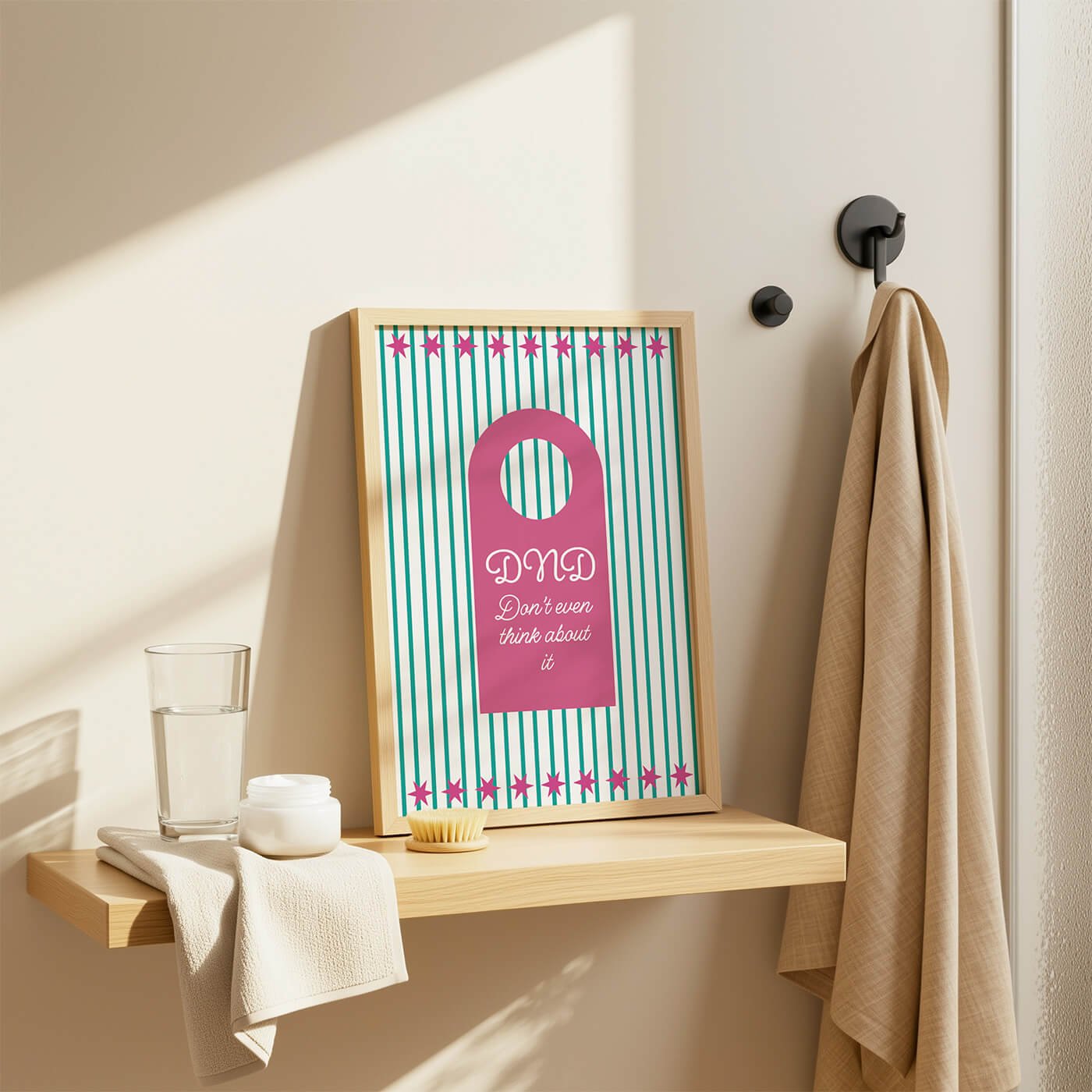 Pink Do Not Disturb Print presented in a wooden frame on a stylish bathroom shelf in a modern bathroom