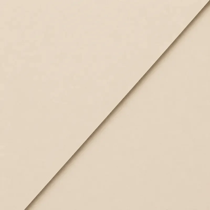 Close-up of beige paper with a diagonal fold.