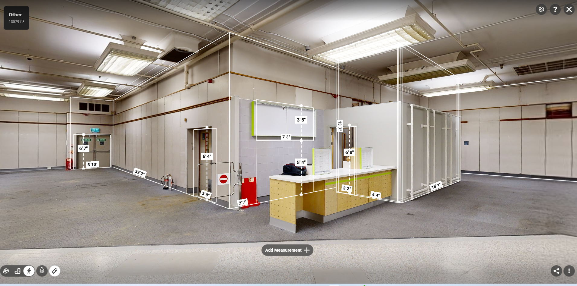 Matterport virtual walkthrough of a warehouse interior with measurement annotations and a service counter