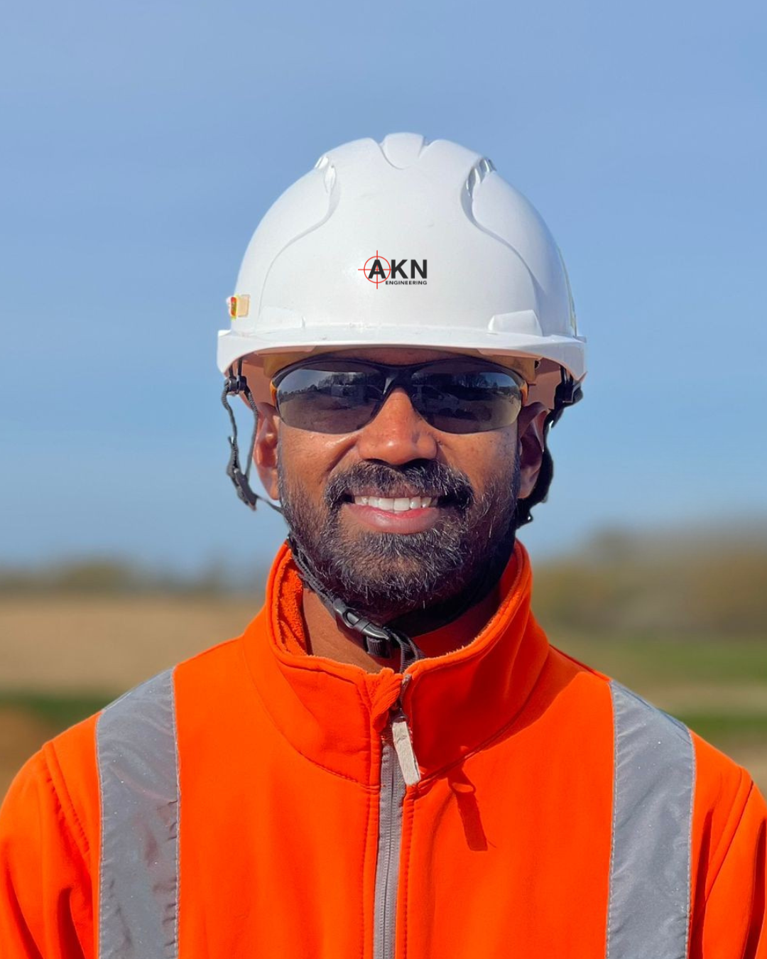 Praveen Anneboina - AKN Engineering - Site Engineer in high vis orange Jacket and White hard hat.