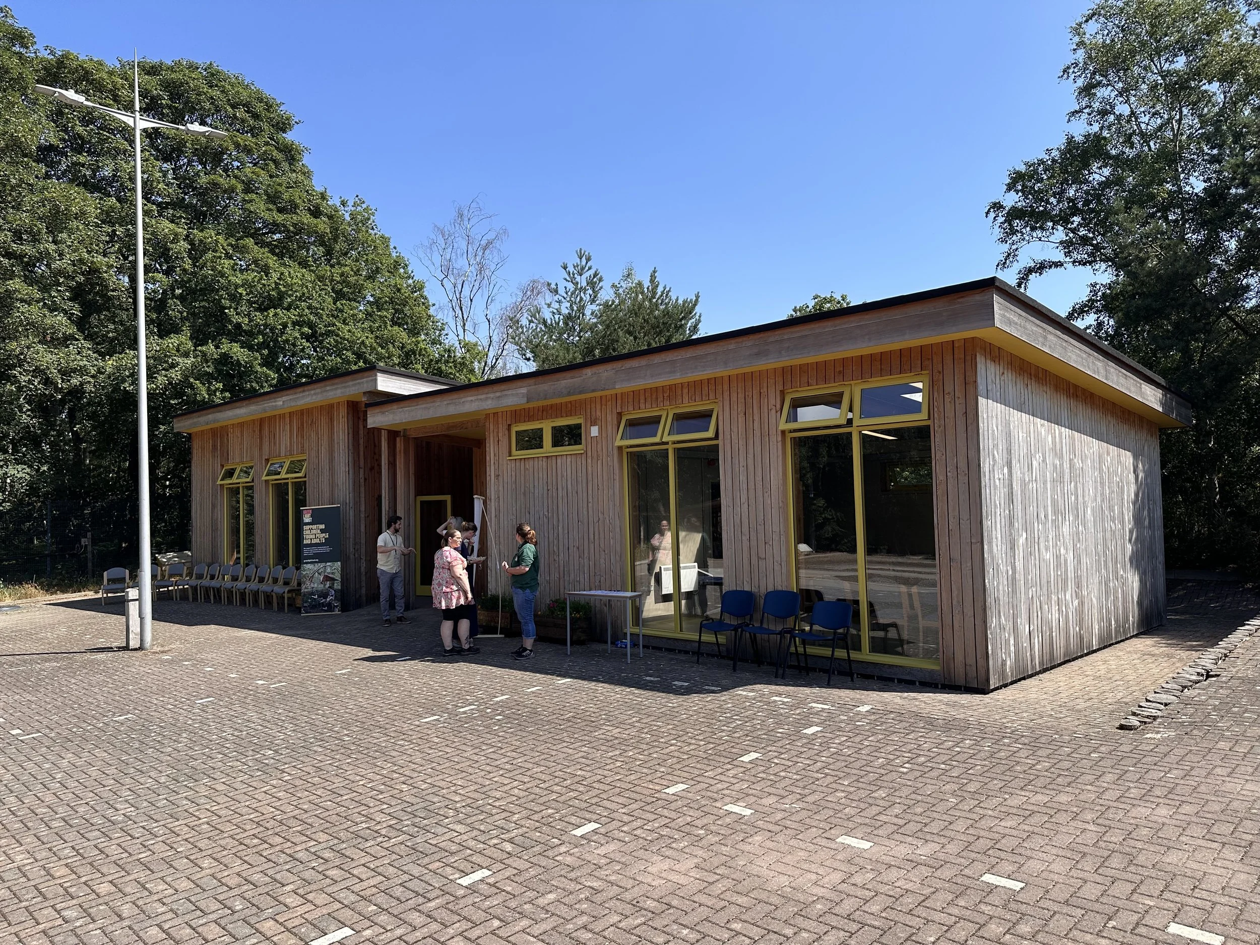A timber building with yellow windows made of the ADEPT modular system