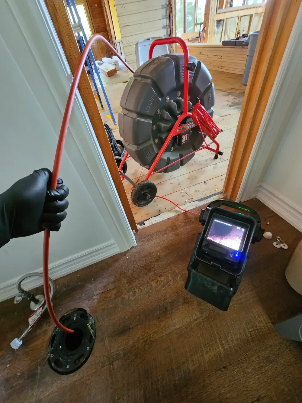 Plumber performing a drain camera inspection of a residential plumbing line in Springwater, Ontario.