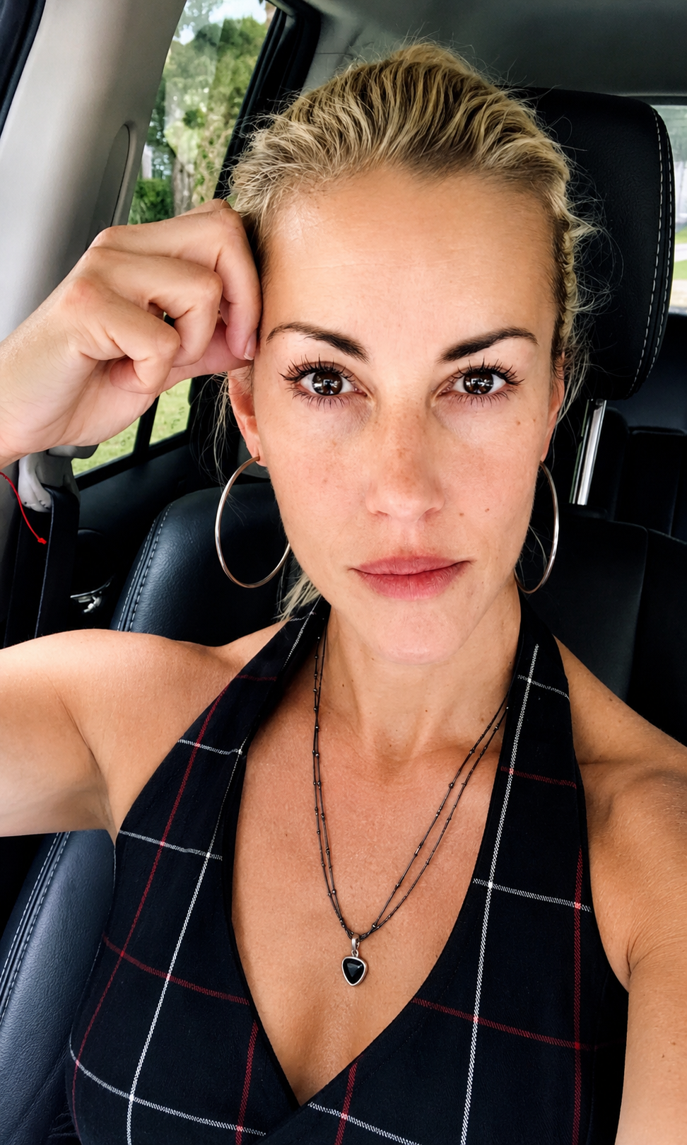 Headshot of Lara Cove with hand to her face.