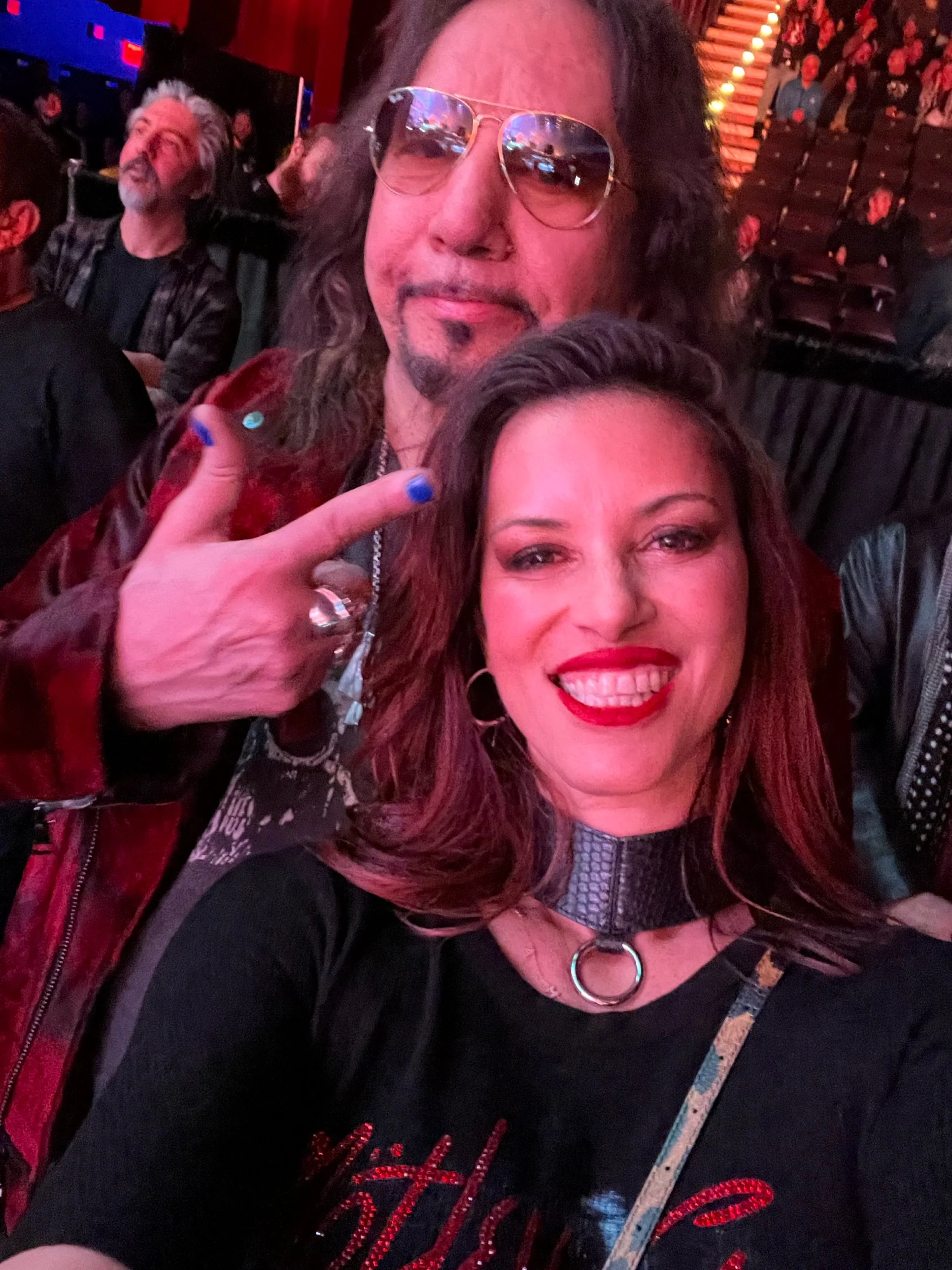 Ace pointing to Lara in collar necklace
