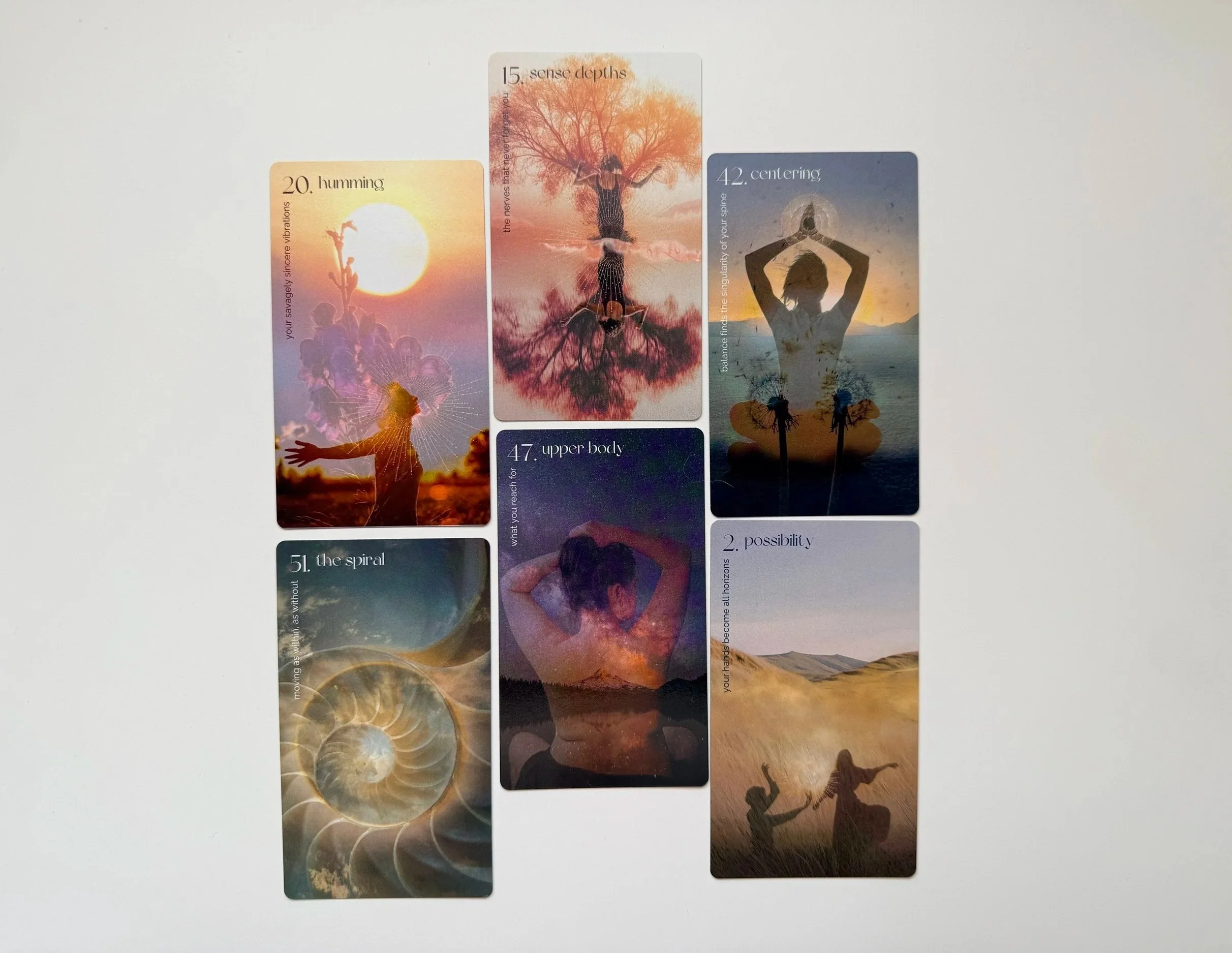 Set of oracle cards with images and words related to mindfulness, spirituality, and personal growth, including themes of senses, centeredness, possibility, and the spiral.