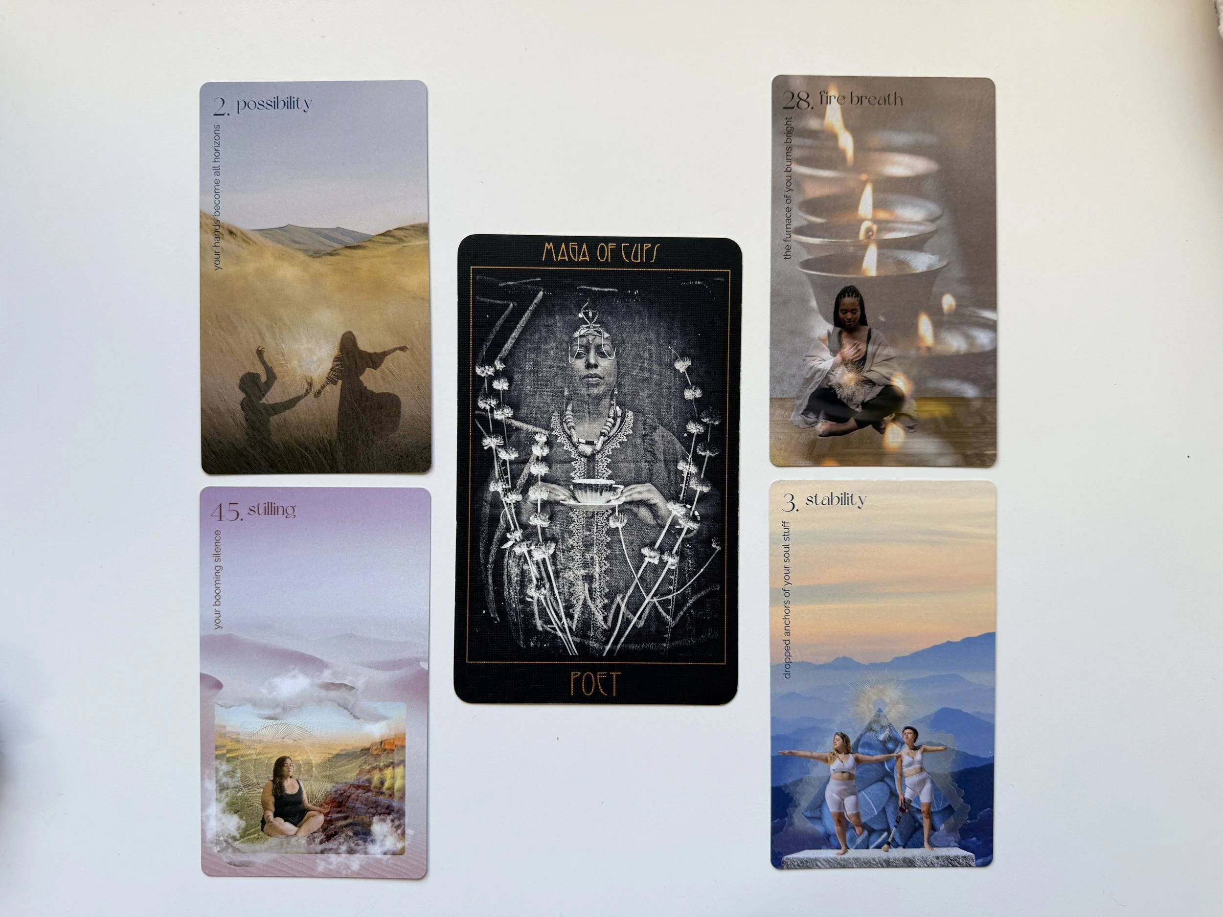 A series of six meditation or affirmation cards with landscape and spiritual imagery. The first card shows two people dancing in a field at sunset. The second card features a mountain scene with a blue sky and text about possibility. The third card displays a woman sitting cross-legged, with a mountain and sunrise background. The fourth card depicts a black and white image of a woman with intricate jewelry and a headdress, titled "Poet". The fifth card shows a mountain landscape at sunrise with a woman meditating on rocks. The sixth card has multiple candles burning with a person sitting in a meditation pose next to them.