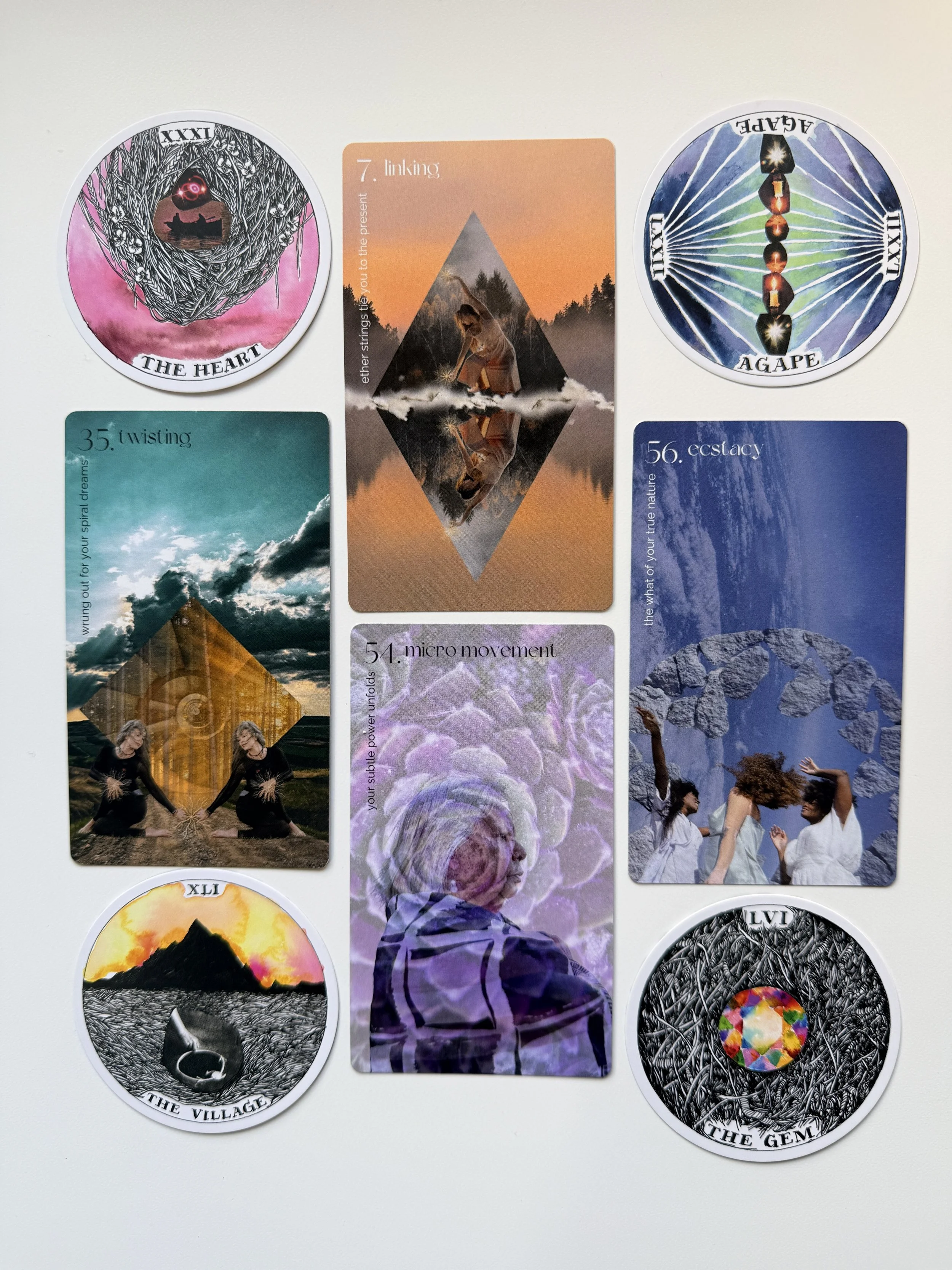 Collection of Oracle cards featuring symbolic images and numbers, including cards labeled 'The Heart,' 'The Village,' and 'The Gem.'