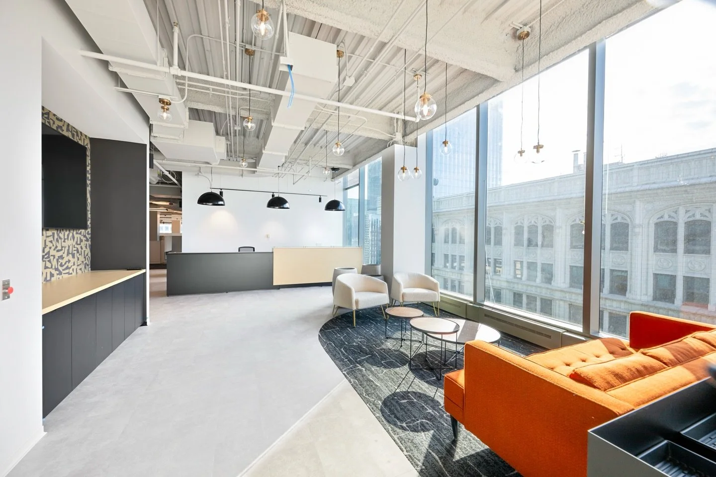 The new R.M. Chin Headquarters blends contemporary design and workplace functionality. Light colored millwork and green accents complement the floor to ceiling, panoramic city views, floor-to-ceiling panoramic city views, creating a bright, inviting,