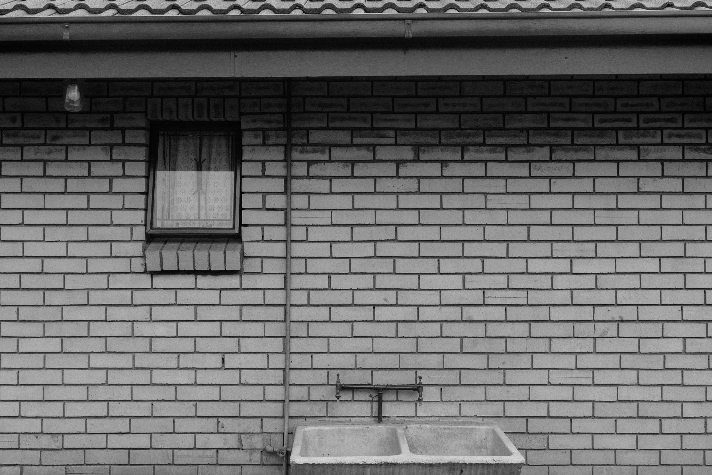 Brick wall with window and outdoor sink
