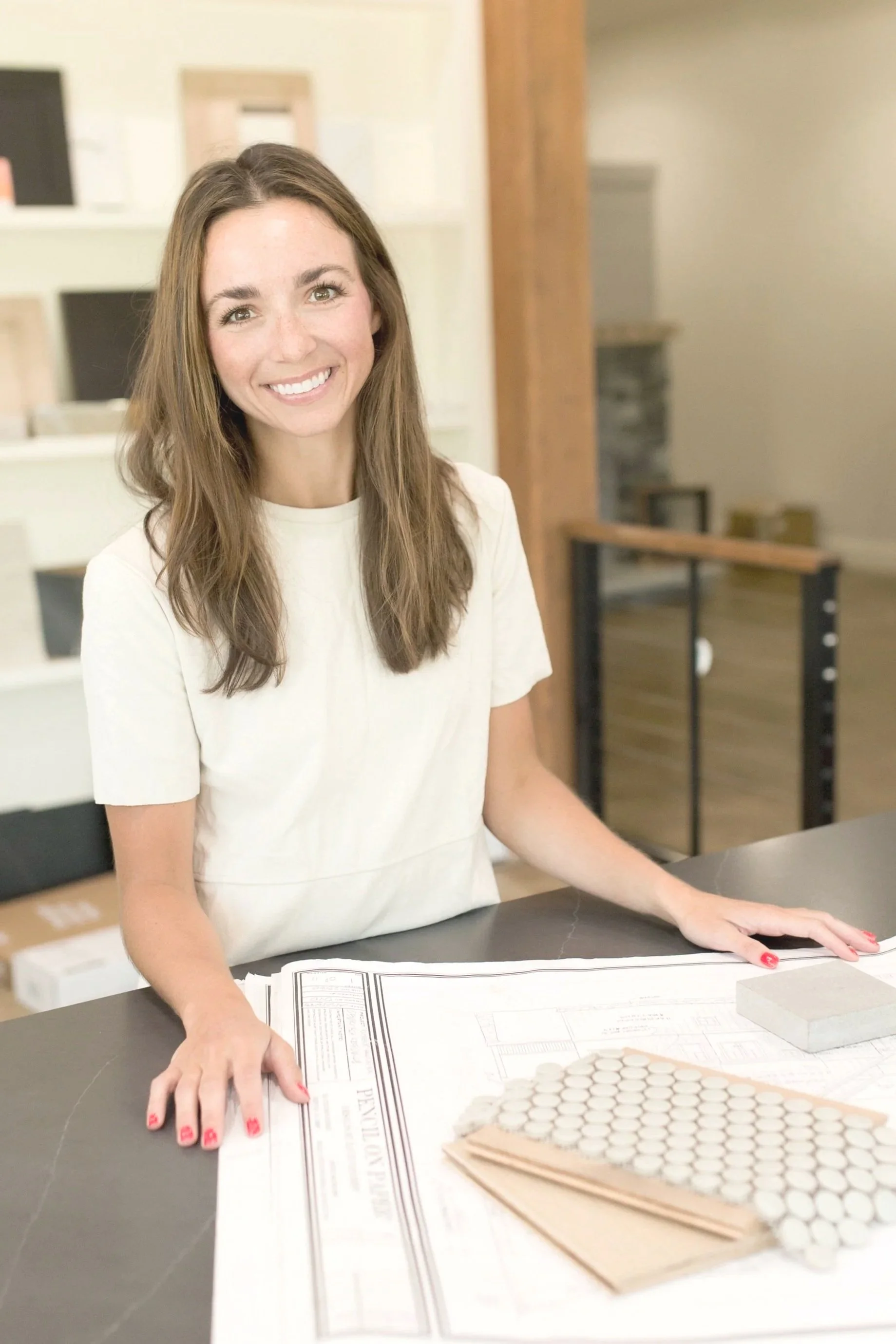 Interior designer with architectural plans and interior design samples