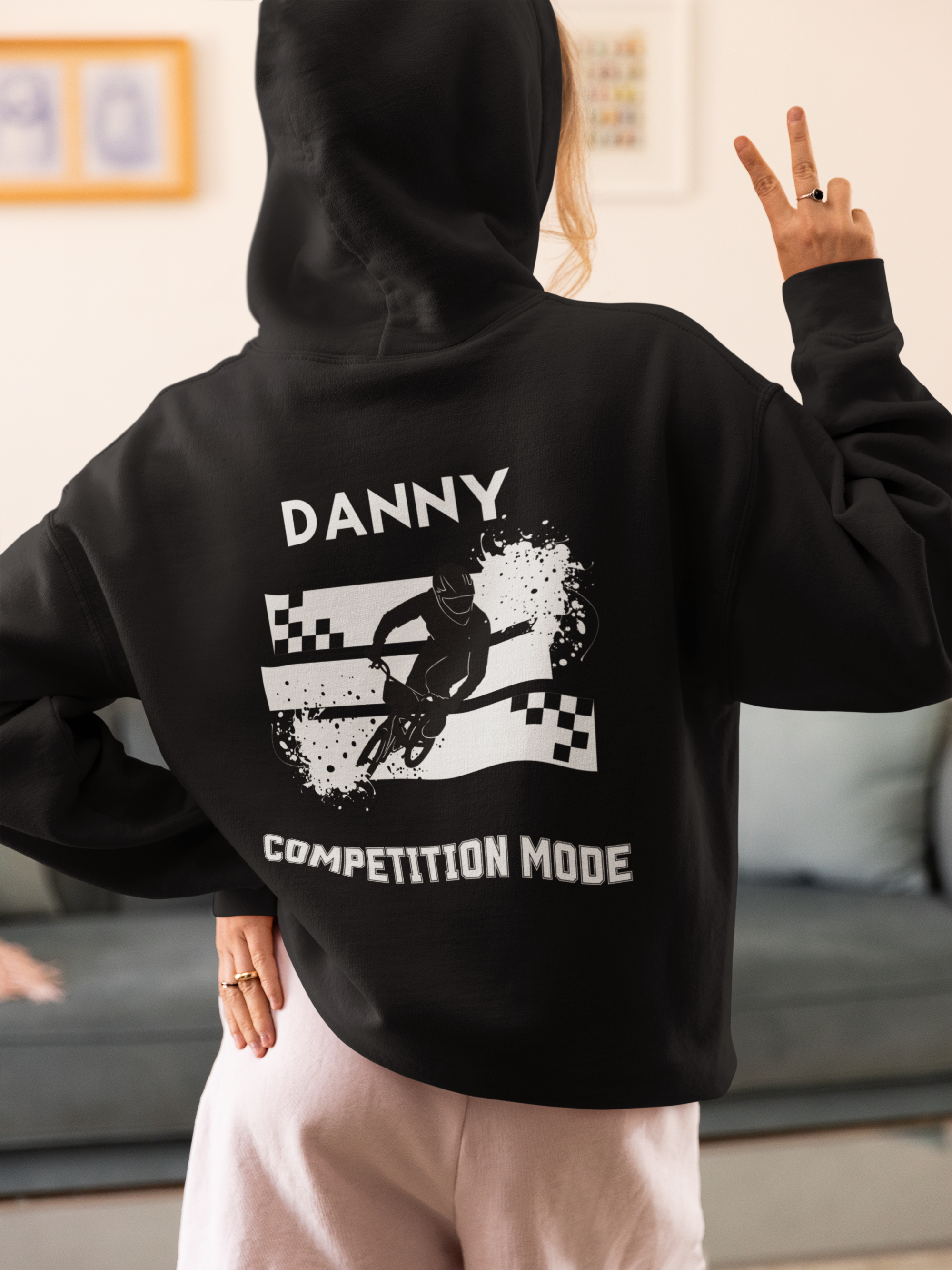 back-view-hoodie-mockup-of-a-woman-in-a-cozy-outfit-making-a-peace-sign-at-home-m37299.png