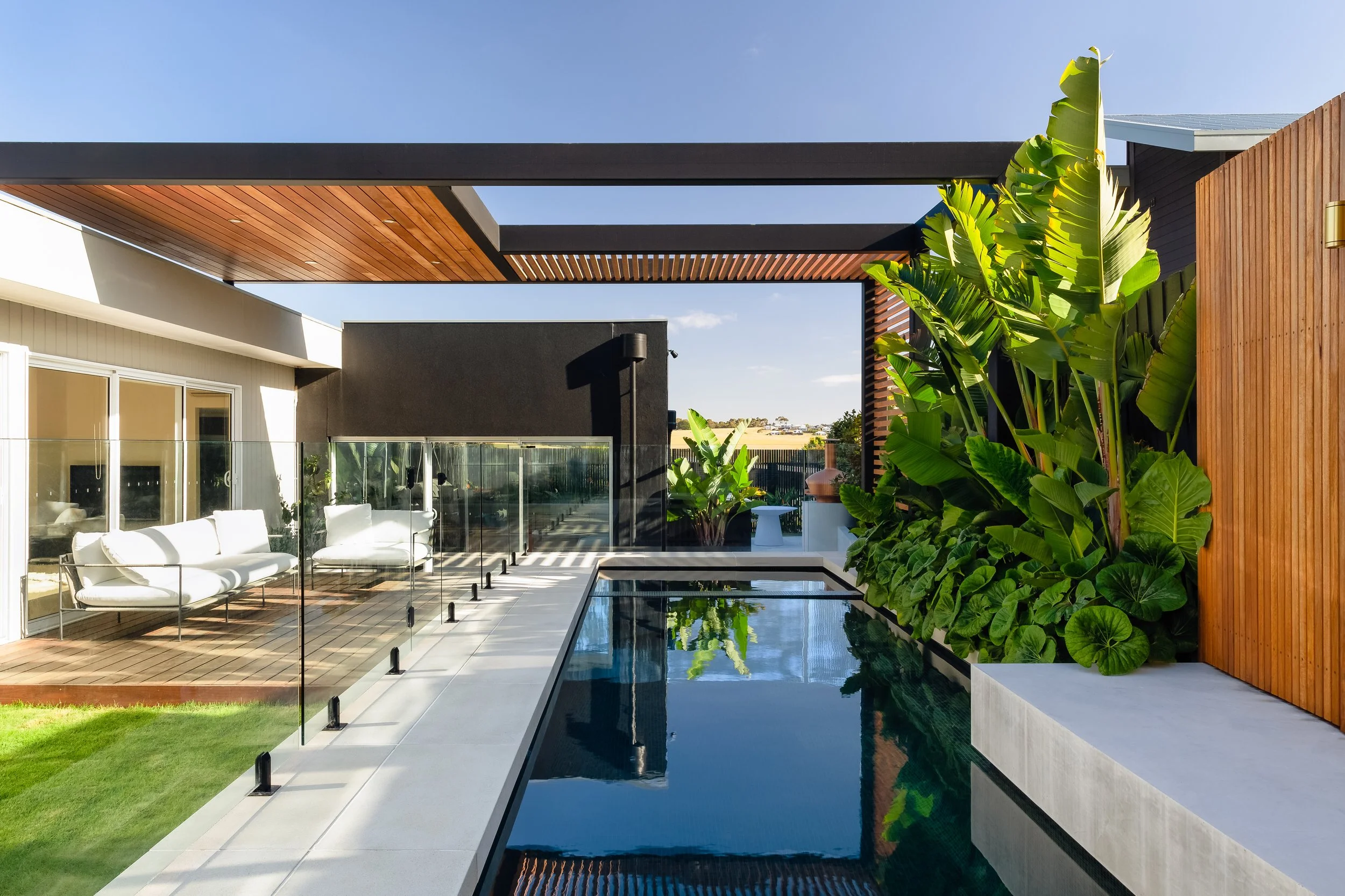 Pool and lush oasis planting by Mint Landscape Design in Torquay