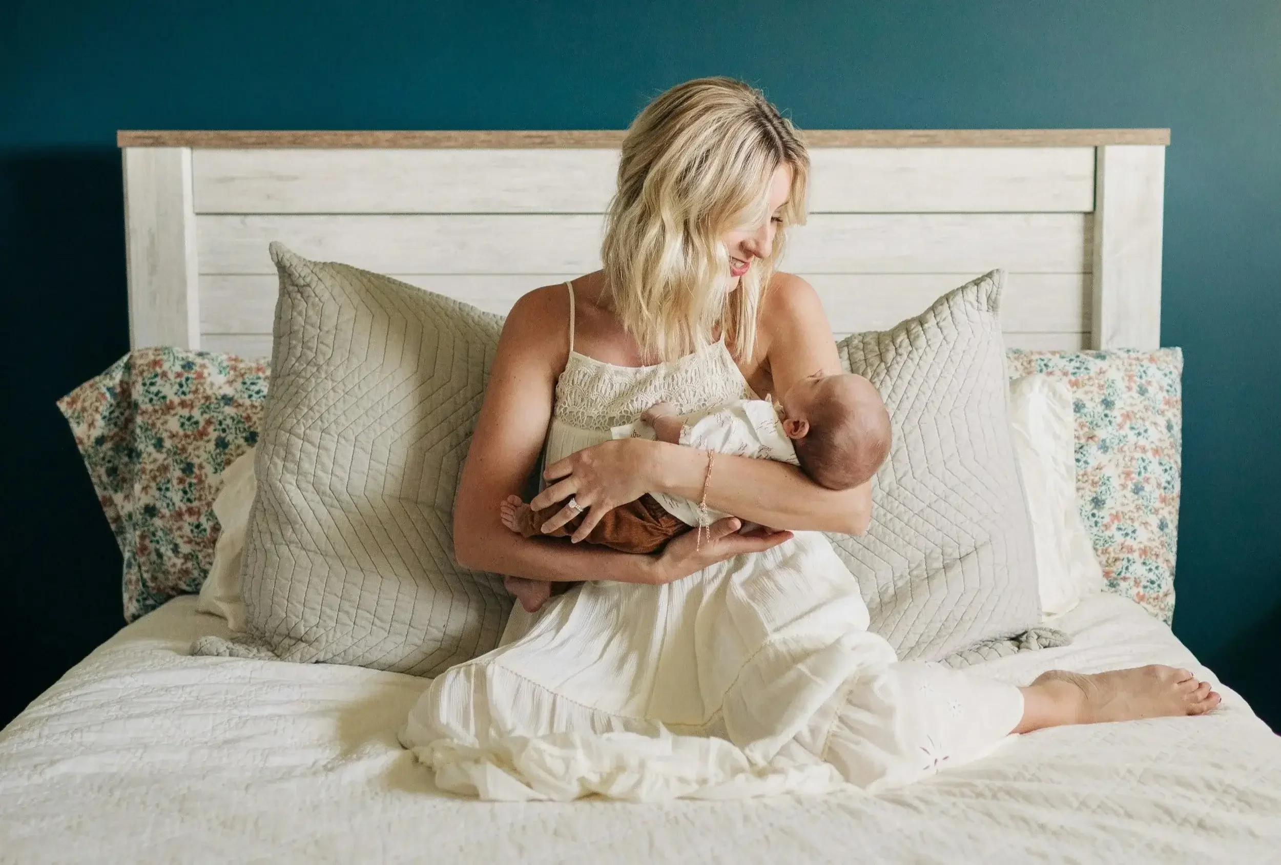 A new mother resting with her newborn at home while navigating postpartum depression.