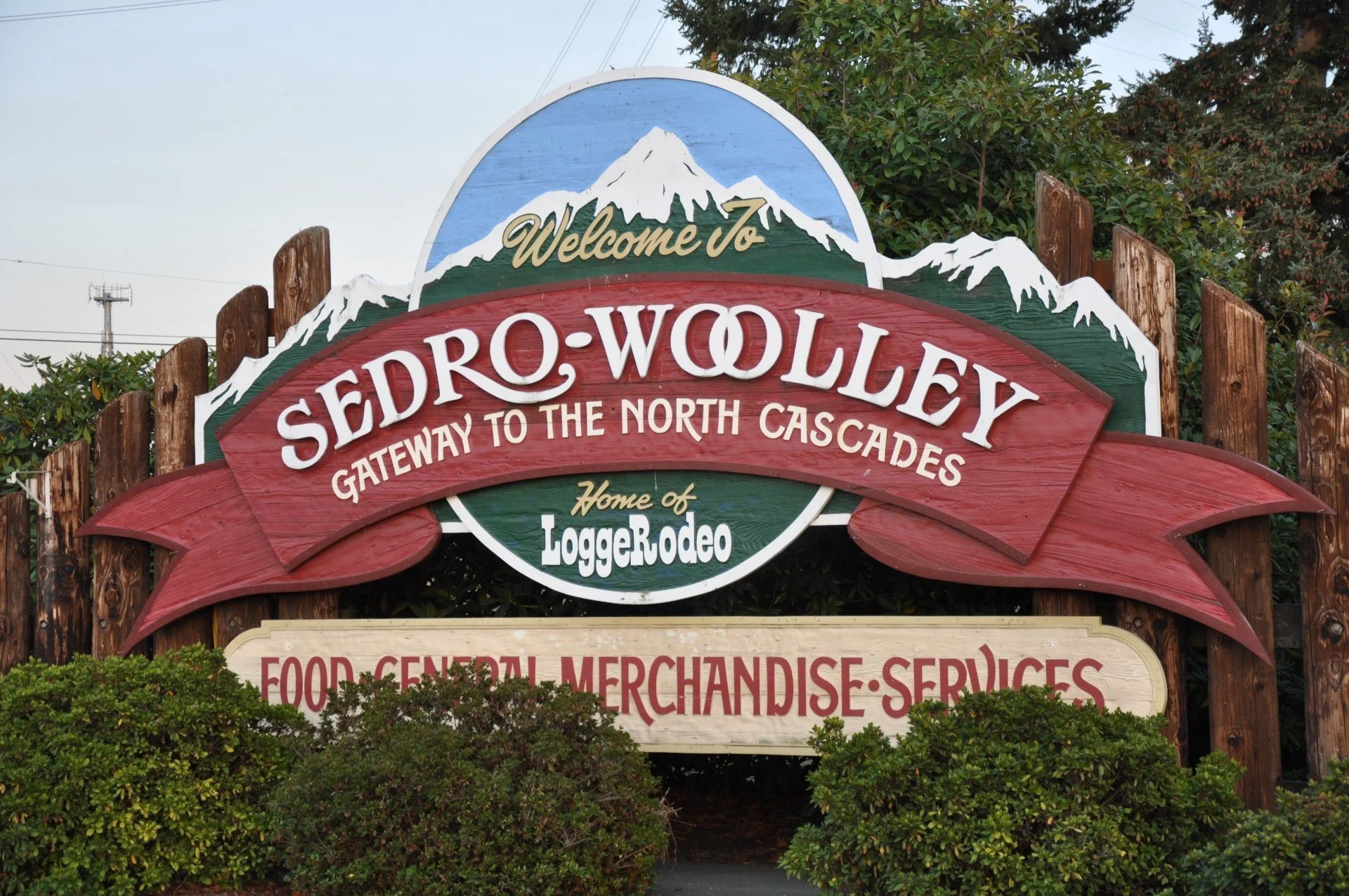 Welcome sign to Sedro-Woolley WA – Gateway to the North Cascades with LoggersRodeo and mountain view