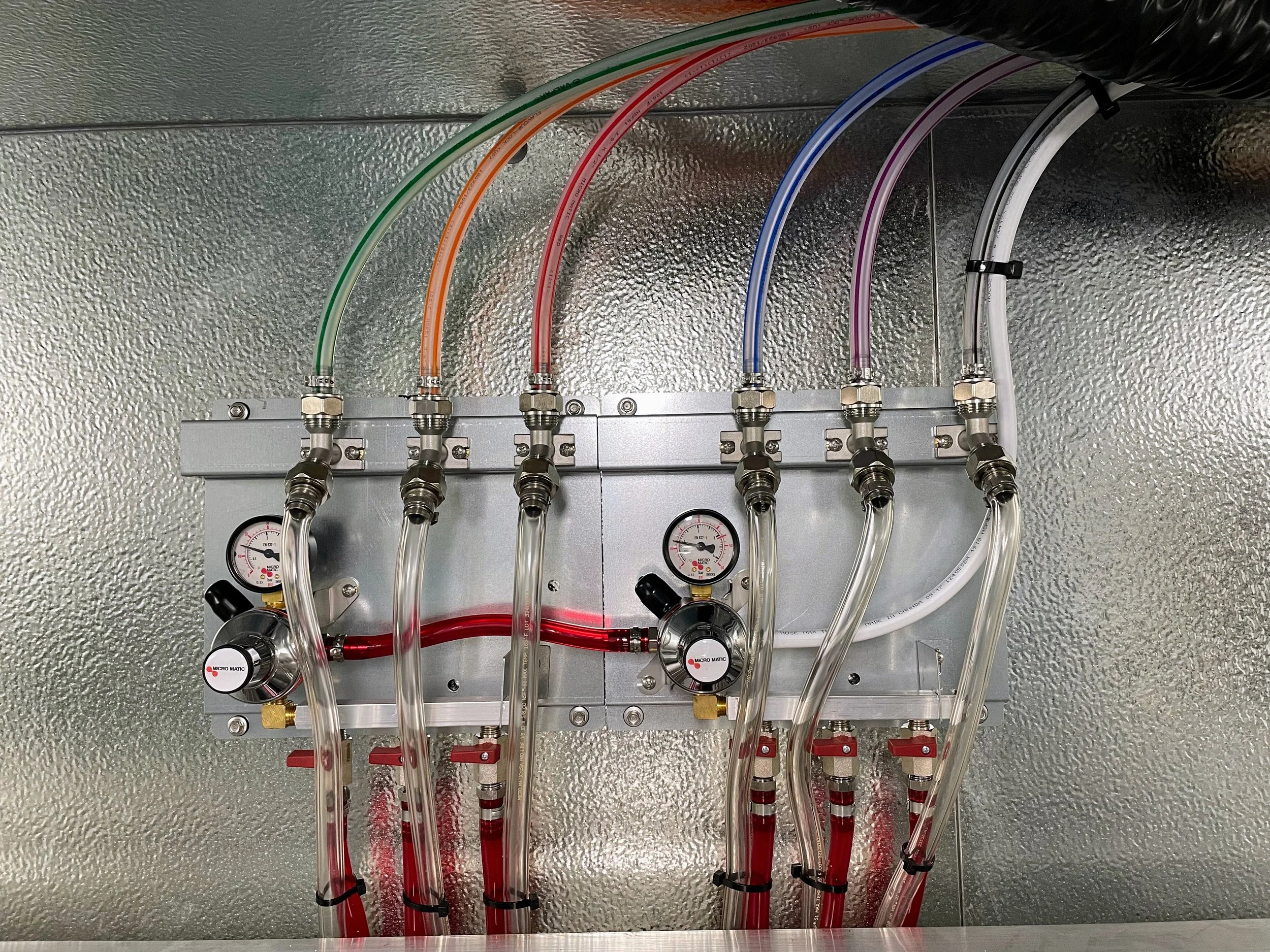 Micro Matic secondary CO2 regulator panels with brand new color-coded Micro Matic trunk line in a professional walk-in cooler draft system installed by Tapworks Northwest in Northwest Washington.