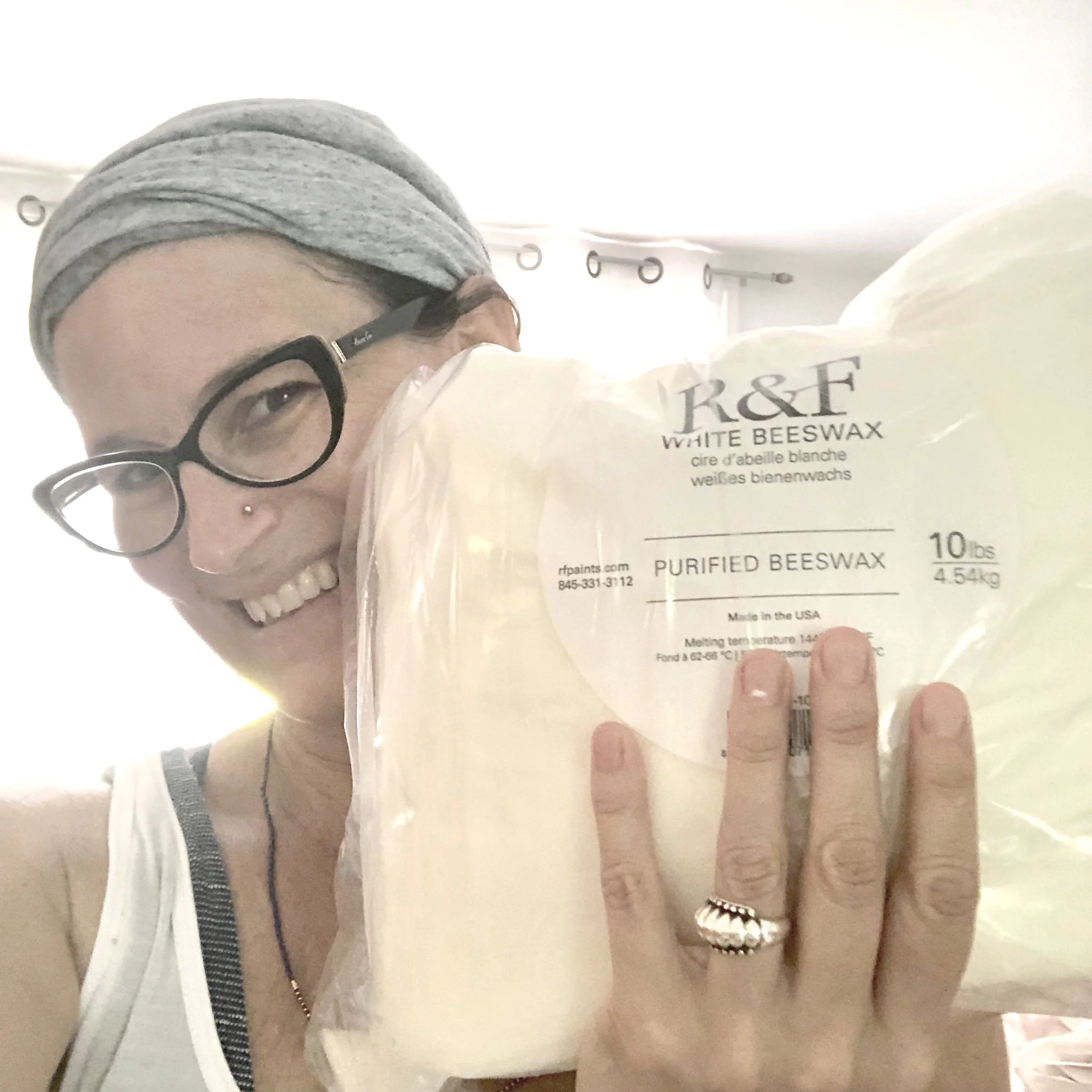 Person holding a package of R&F white purified beeswax