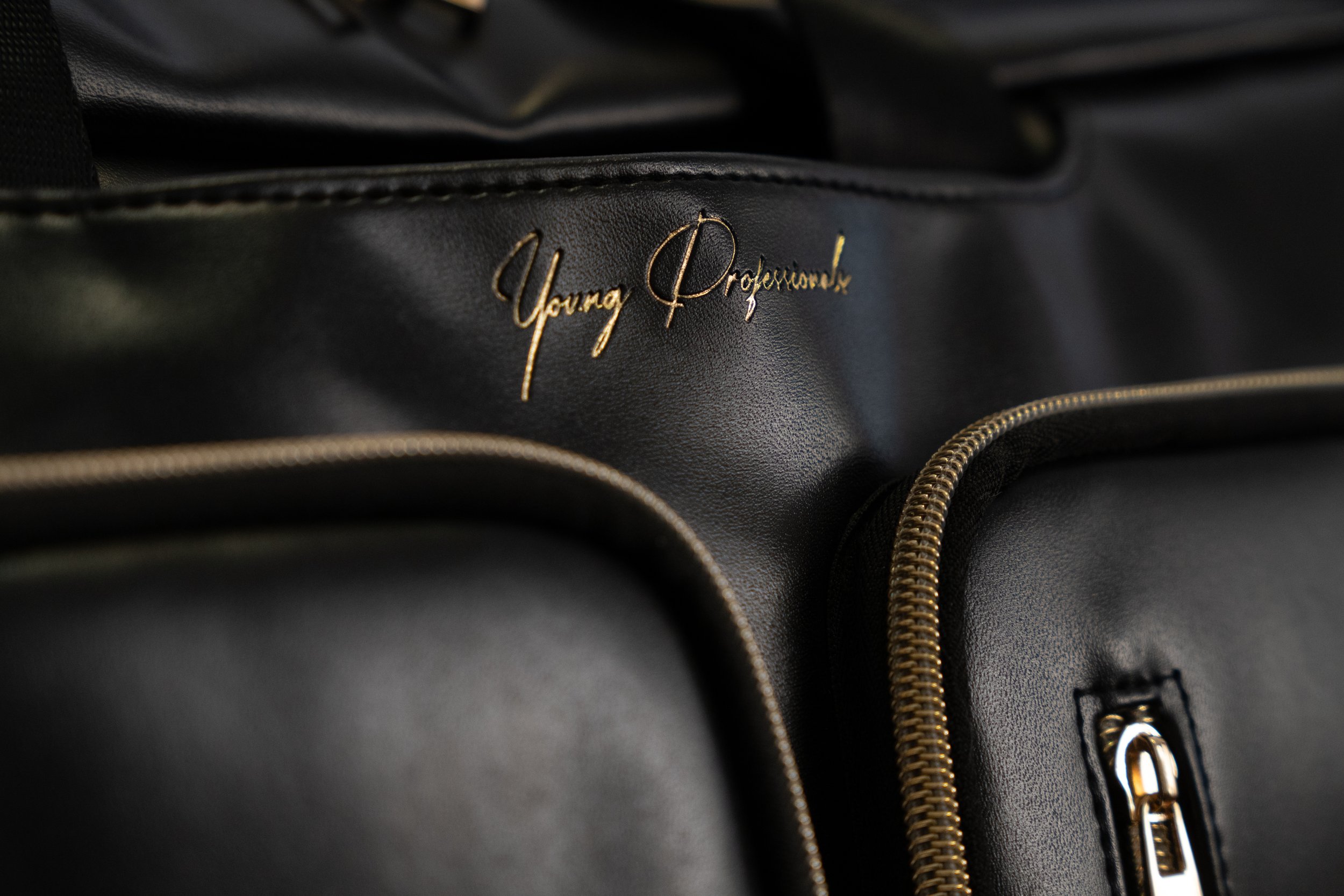 Accessory product photography in San Francisco. Backpack / briefcase closeup of logo from Young Professionals.