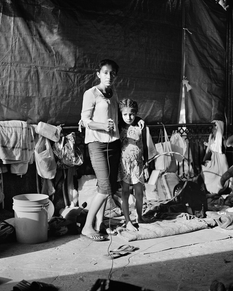 3. Rosa Arévalo, 25, with her daughter, Kendra, 7, from Guatemala, at an informal migrant camp in Reynosa, Mexico. Photograph by Rosa Arévalo and Adam Ferguson.