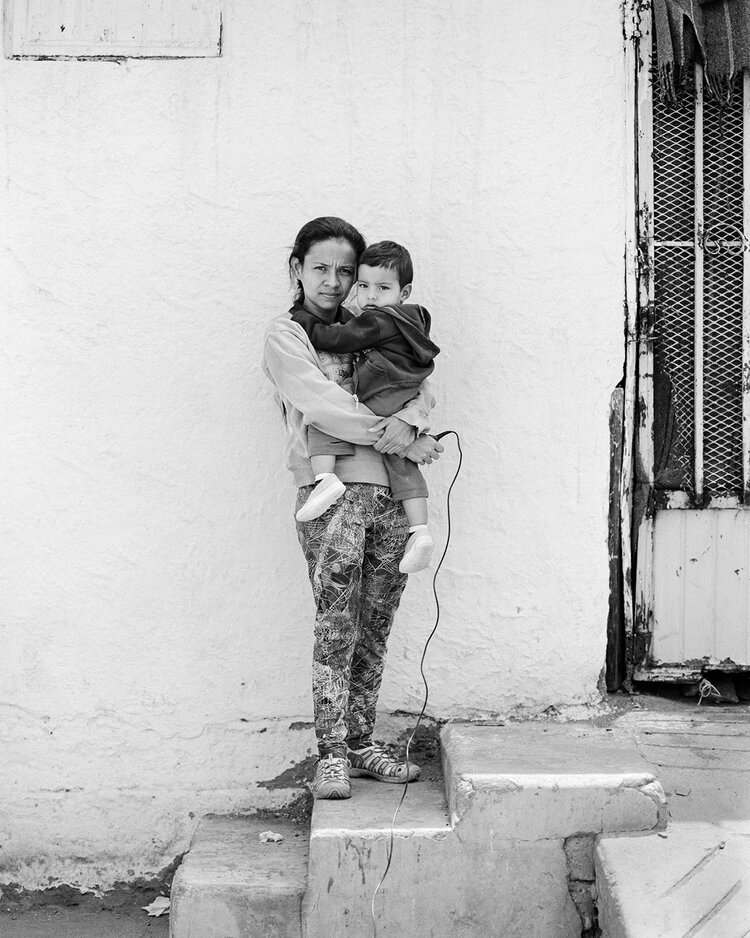 9. Belkis Quiroz, 26, with her son Santiago, 1, from Honduras, at Enrique Romero Municipal Gymnasium in Ciudad Juárez, Mexico. Photograph by Belkiz Quiroz and Adam Ferguson.