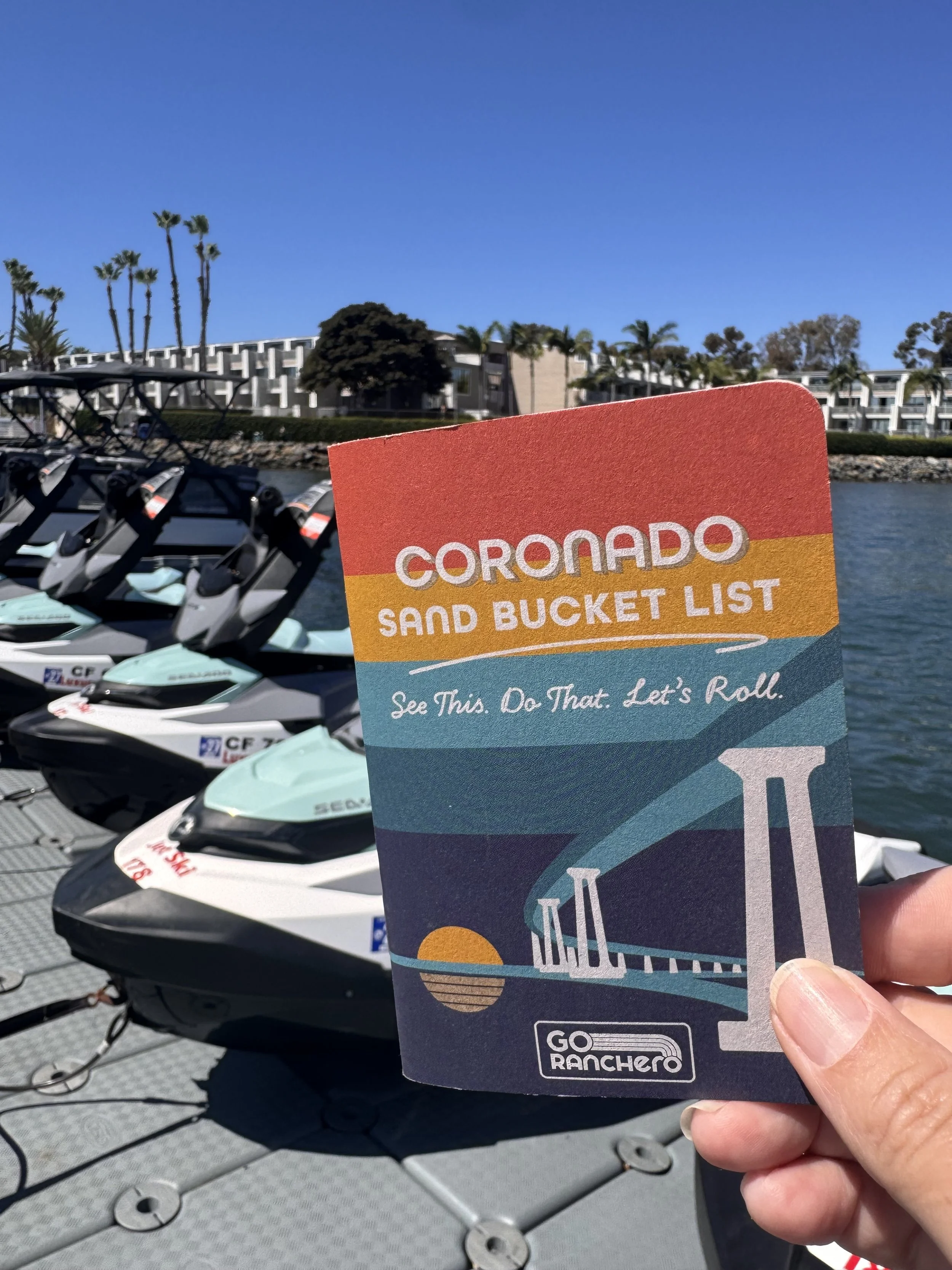 Coronado Sand Bucket List with jet skis on San Diego Bay in the background