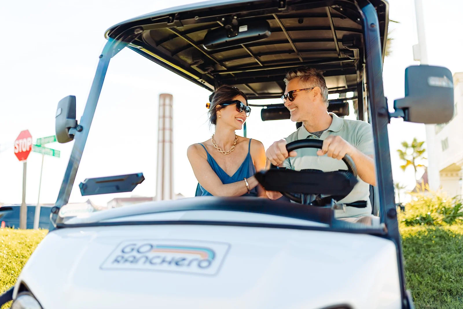 Couple enjoying a Go Ranchero street-legal golf cart in Coronado, California