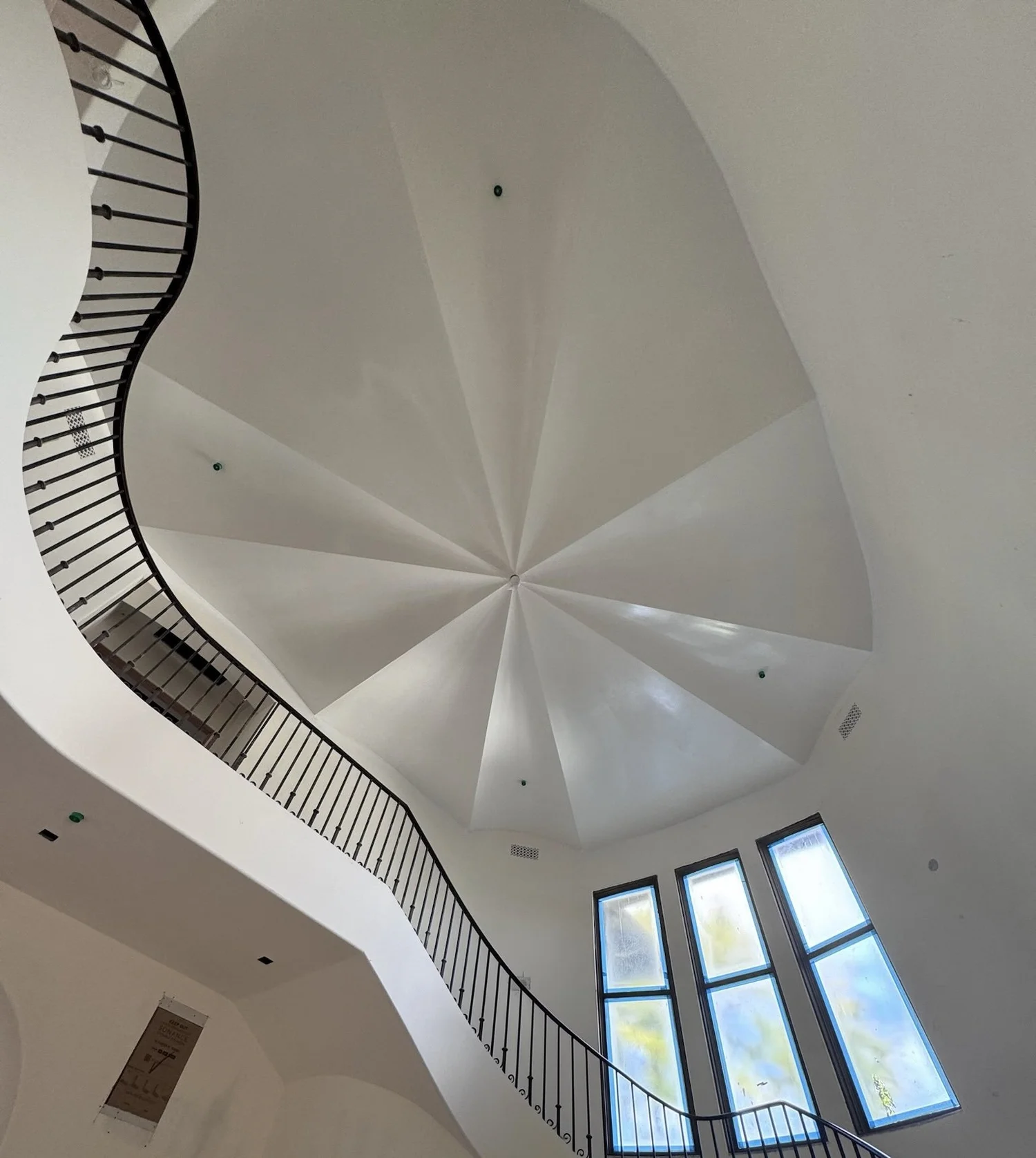 Sculpted GFRC ceiling above a curved staircase