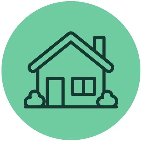 Icon of a house with bushes, inside a green circular background.