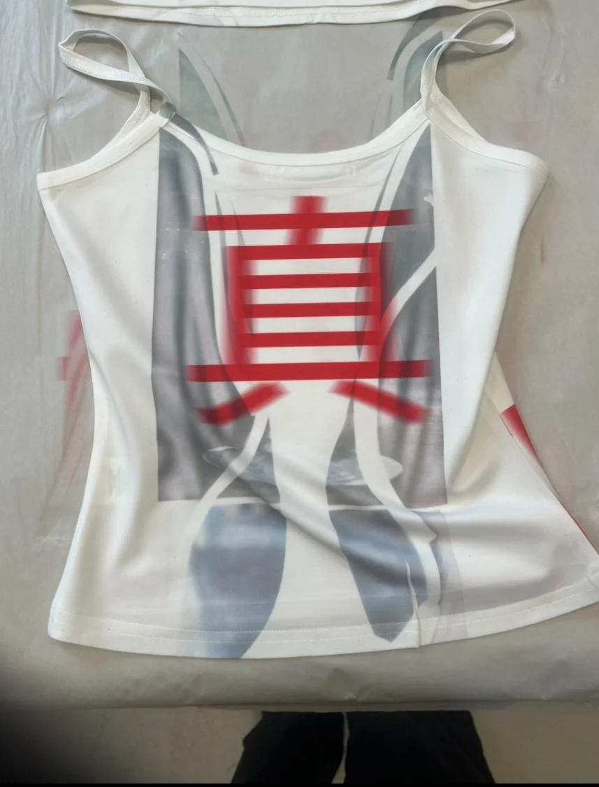 White mesh cami top with bold red Chinese character 真 (truth) layered over a grayscale abstract print.