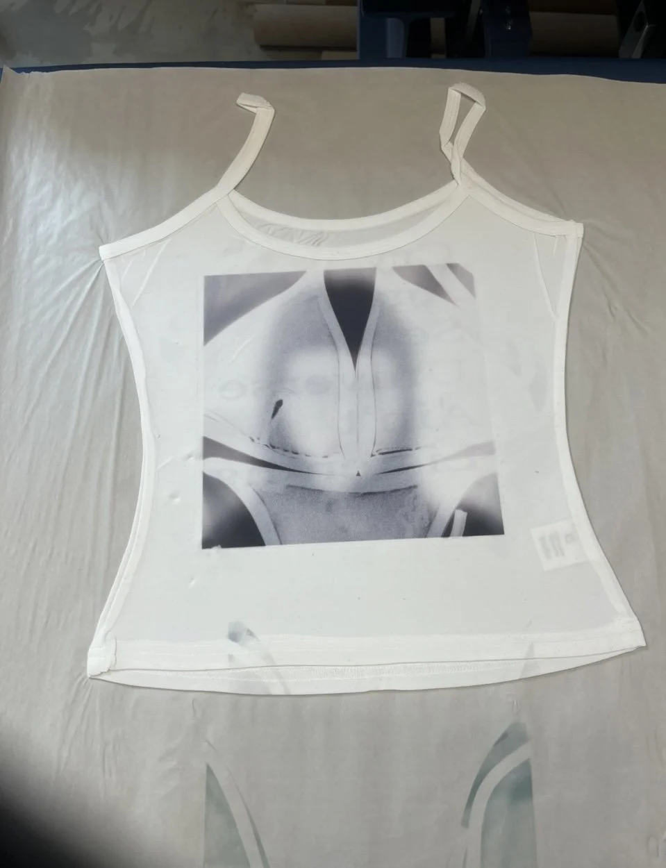 y2k graphic tank, artistic fashion, subversive basics, femme nihilism, white camisole printed with abstract black-and-white x-ray of pelvis or torso.