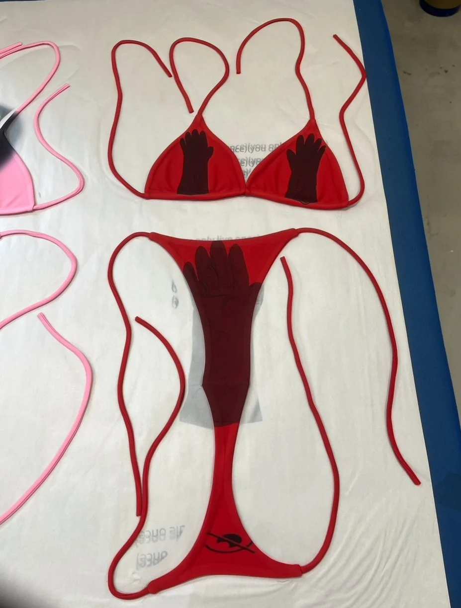 Red bikini set printed with winter gloves on top and censorship icon on bottom