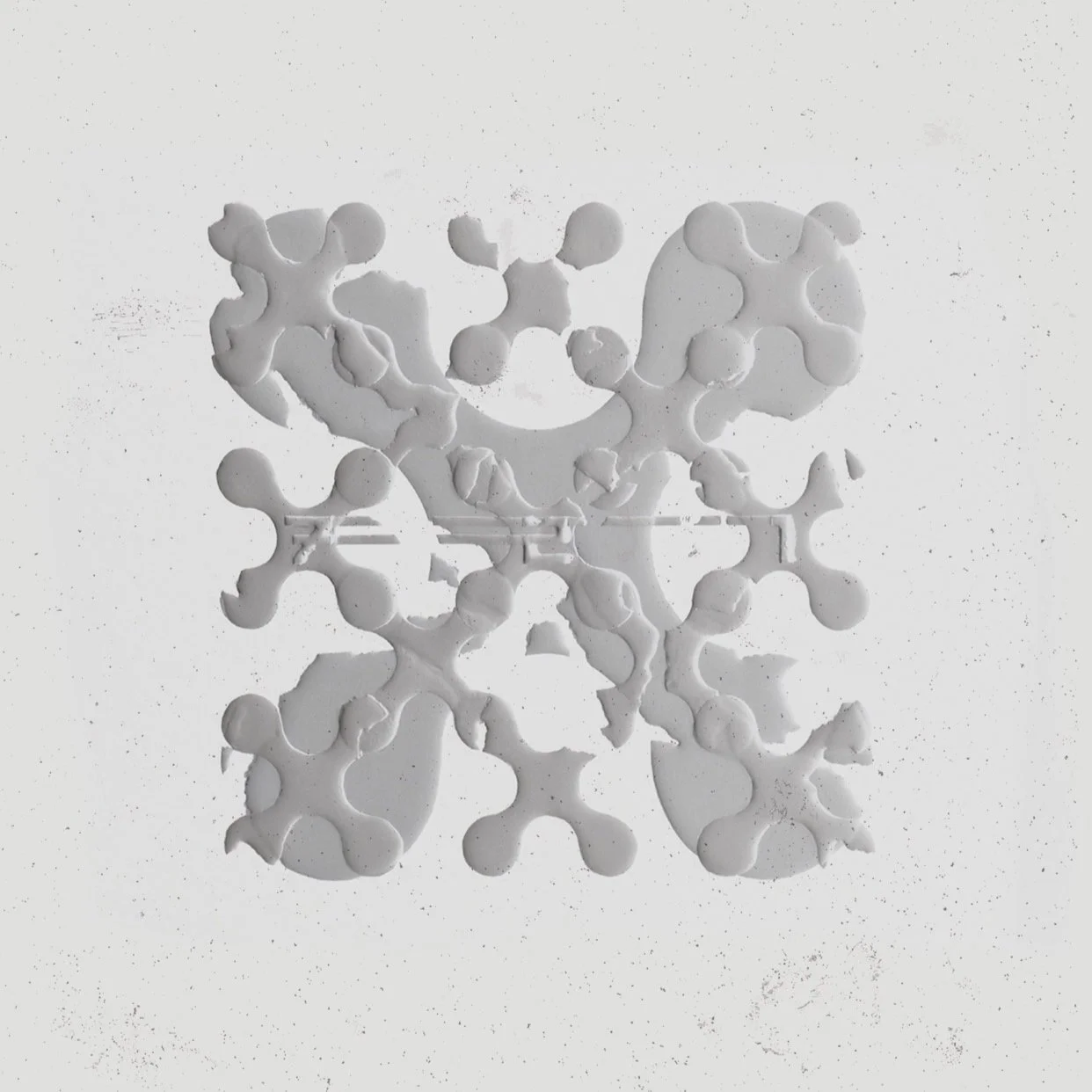 White abstract pattern on a light background with circular and rounded shapes.