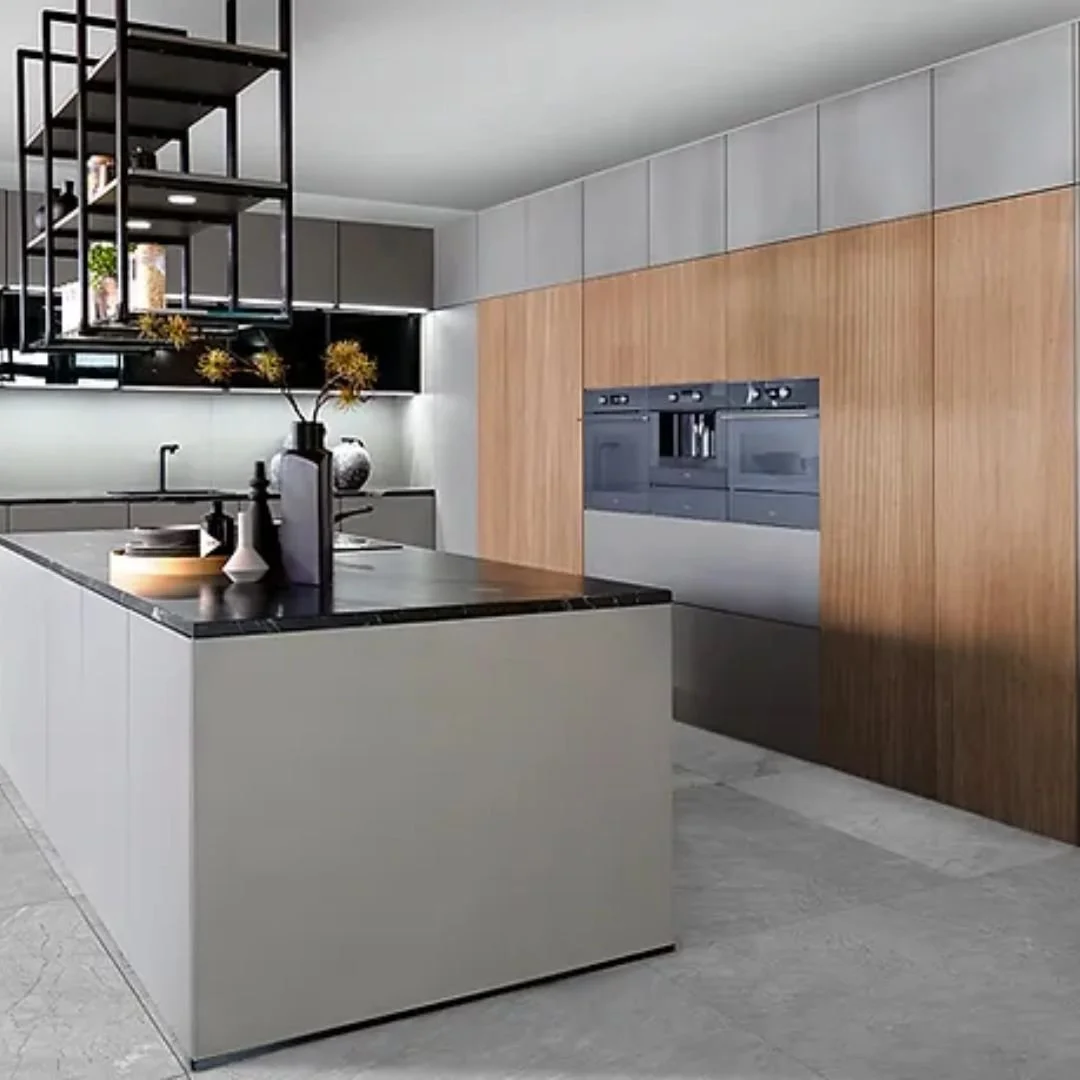 Modern kitchen with a gray island, black countertop, and decorative vases, with wooden and gray cabinetry and built-in appliances.