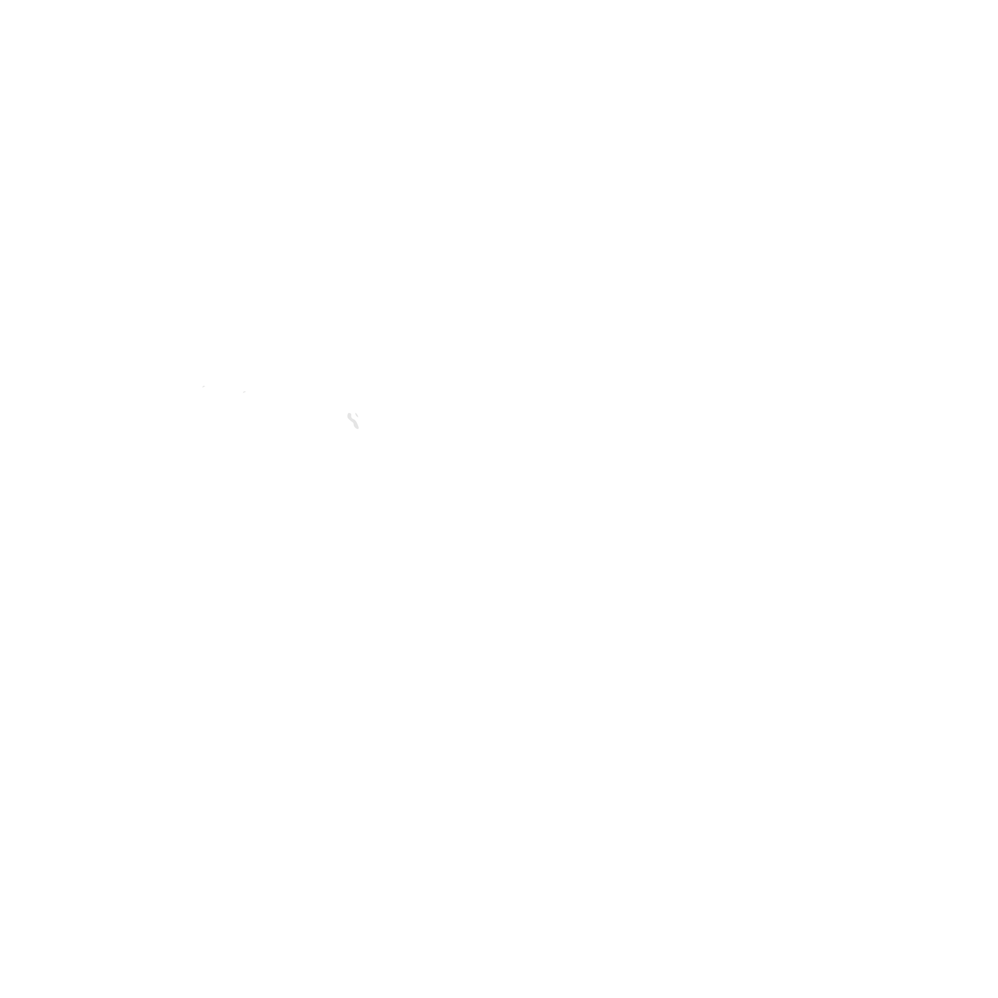 Silhouette of a person sitting at a desk with a laptop and a coffee mug, with a cityscape window view.