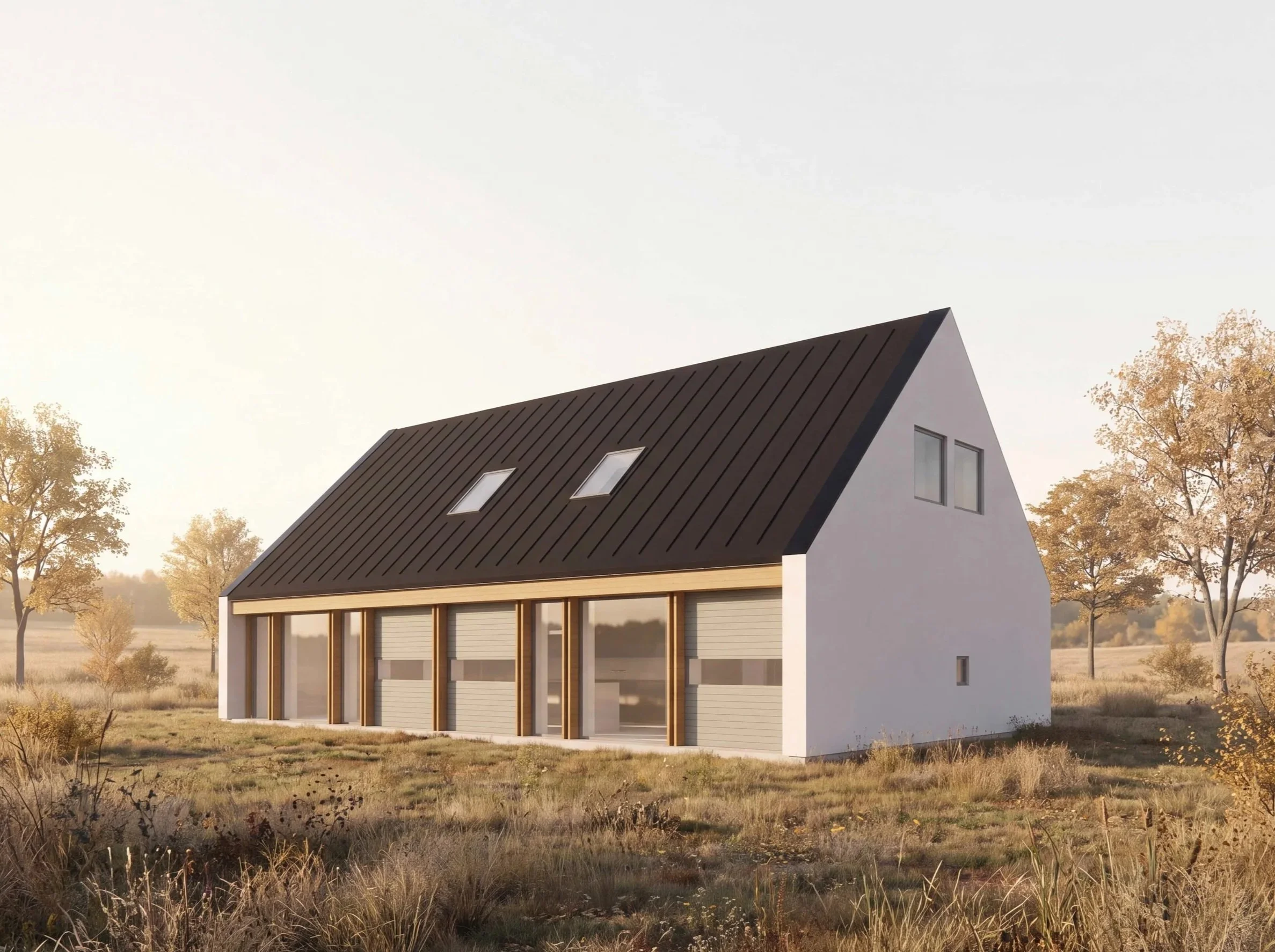 Moderne hus med svart sadeltak, stora fönster och en träutbyggnad på framsidan, omgiven av höstfärgade träd och ett öppet landskap.