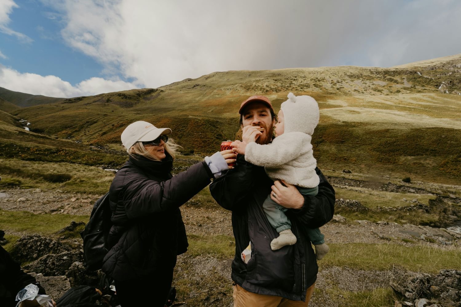 Family on a hike eating a snack.
