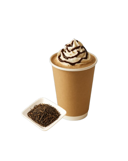 A hot beverage topped with whipped cream and chocolate drizzle, served in a brown paper cup, with a small bowl of loose tea leaves beside it.