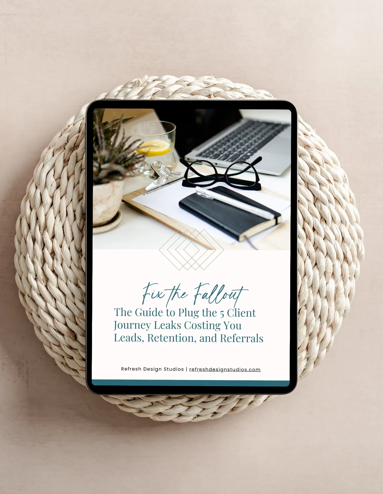 A boho rattan round with an iPad on top displaying the cover of Fix the Fallout