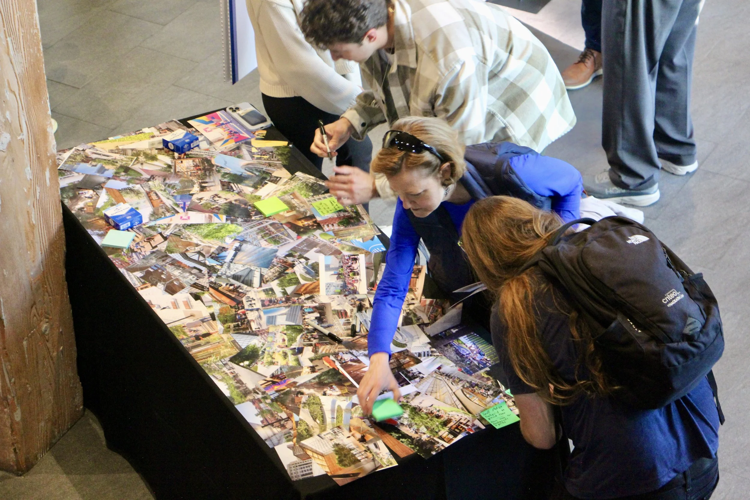 People picking out inspiration photos from a table at a community workshop