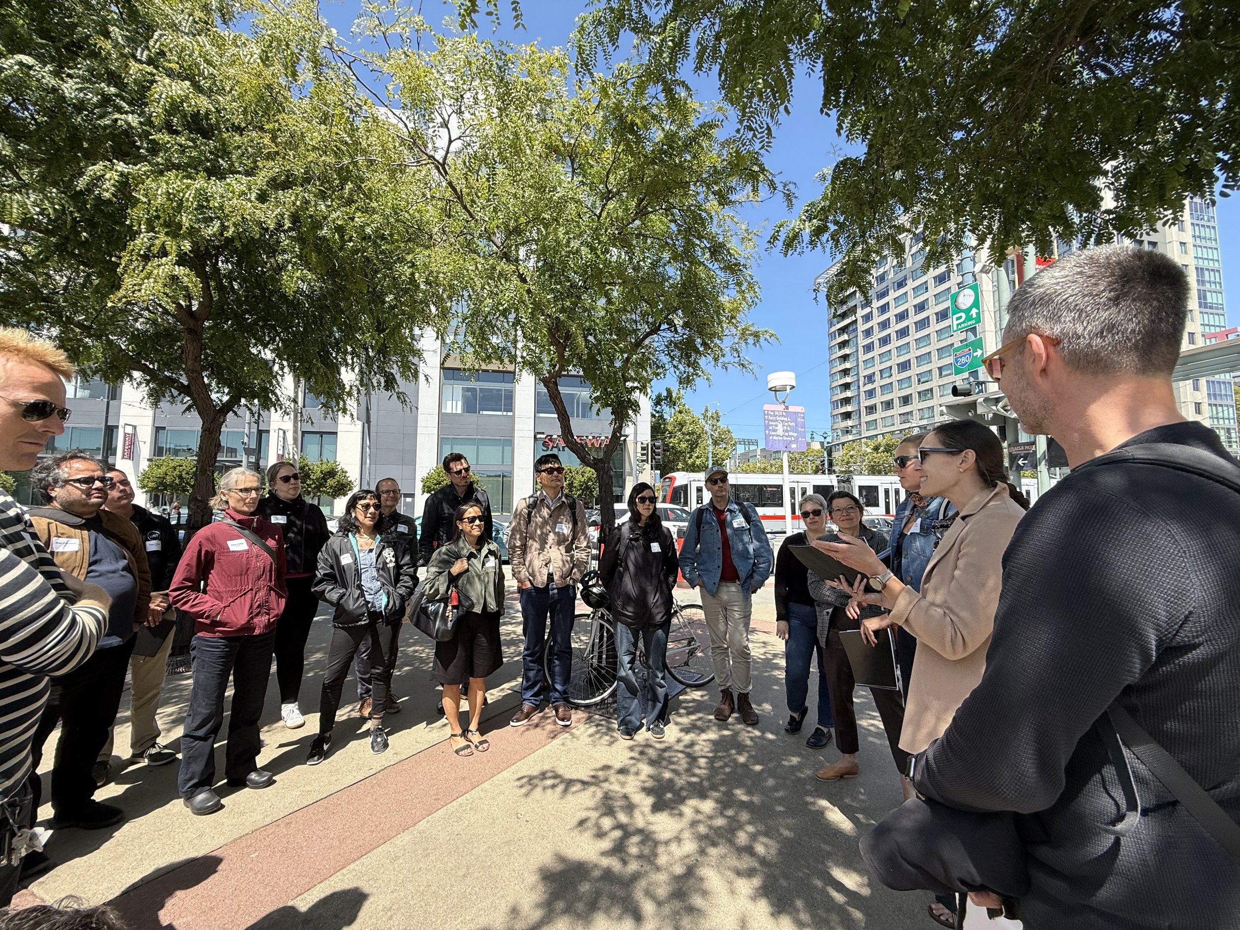 People standing outside Caltrain station during a site tour